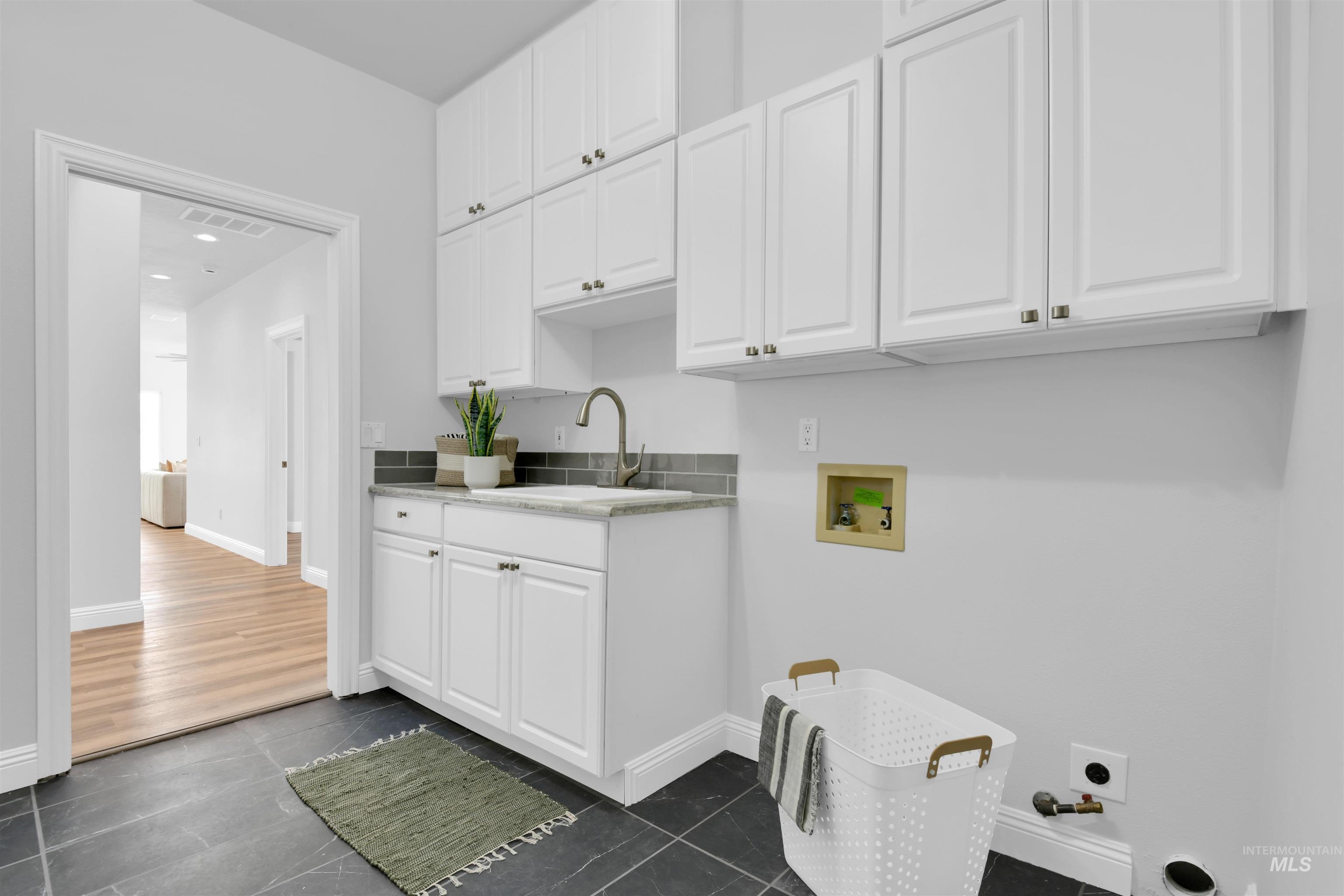 Laundry area featuring hookup for a washing machine, cabinet space, and hookup for an electric dryer