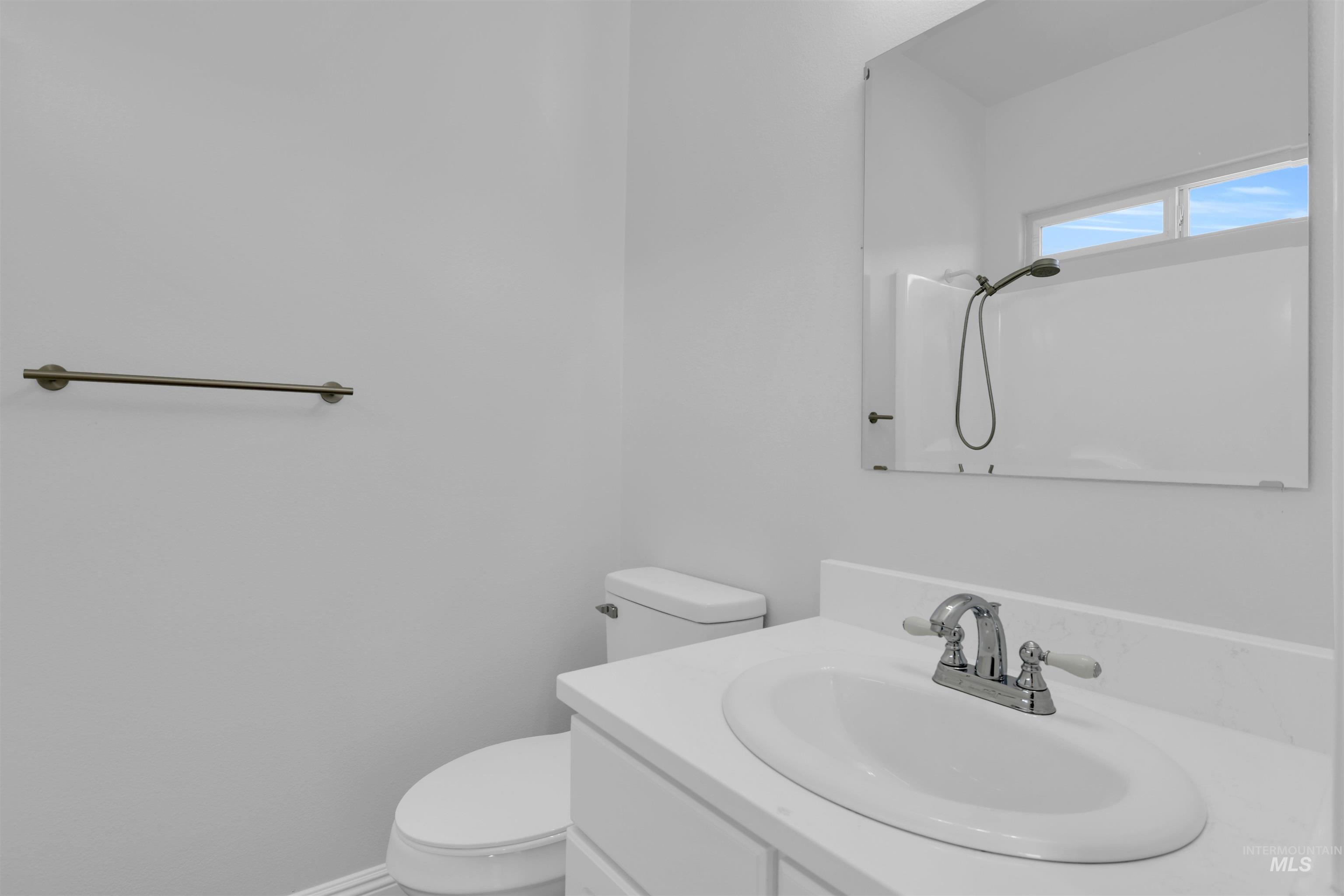 Bathroom featuring vanity and a shower