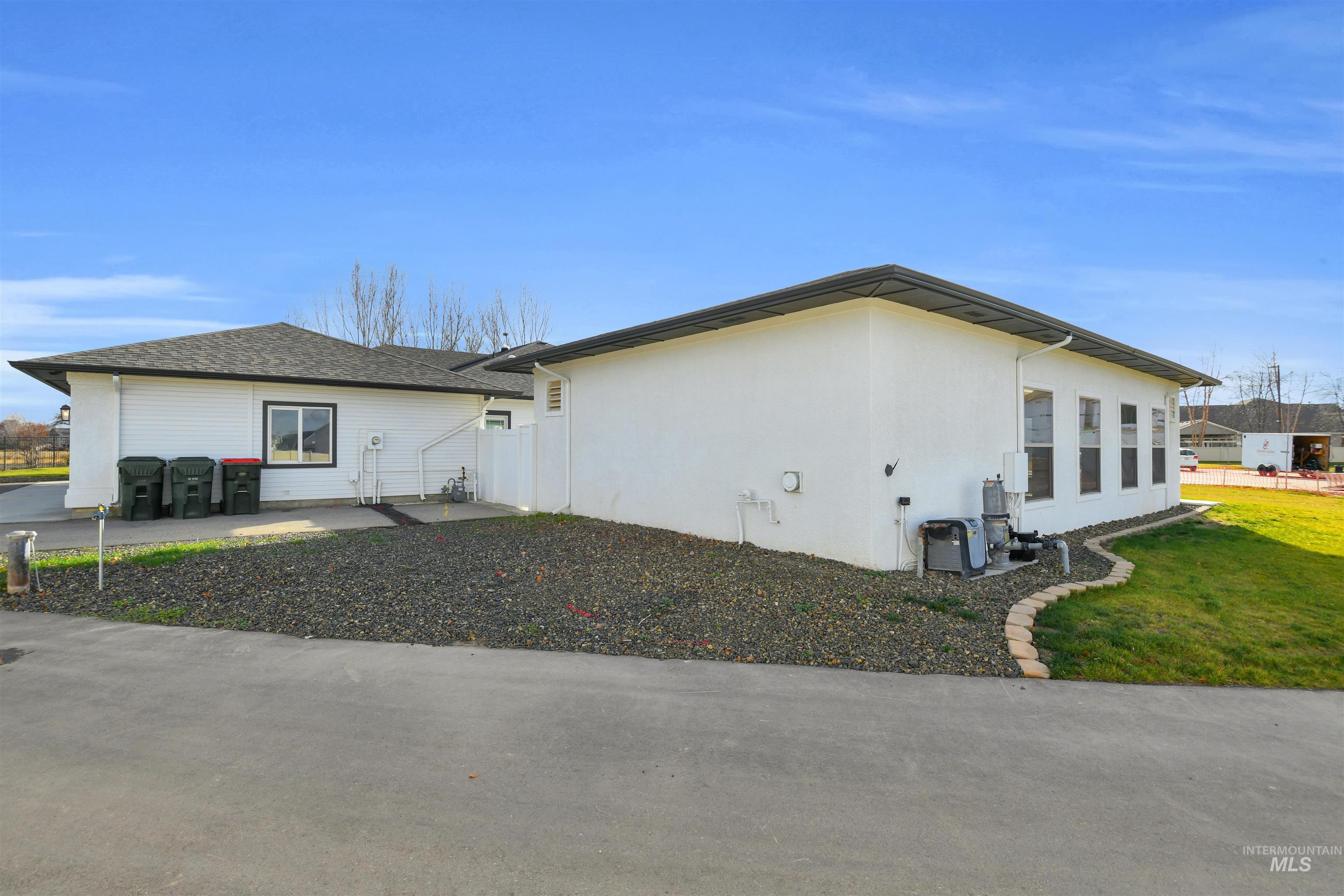 View of side of home with stucco siding and a lawn