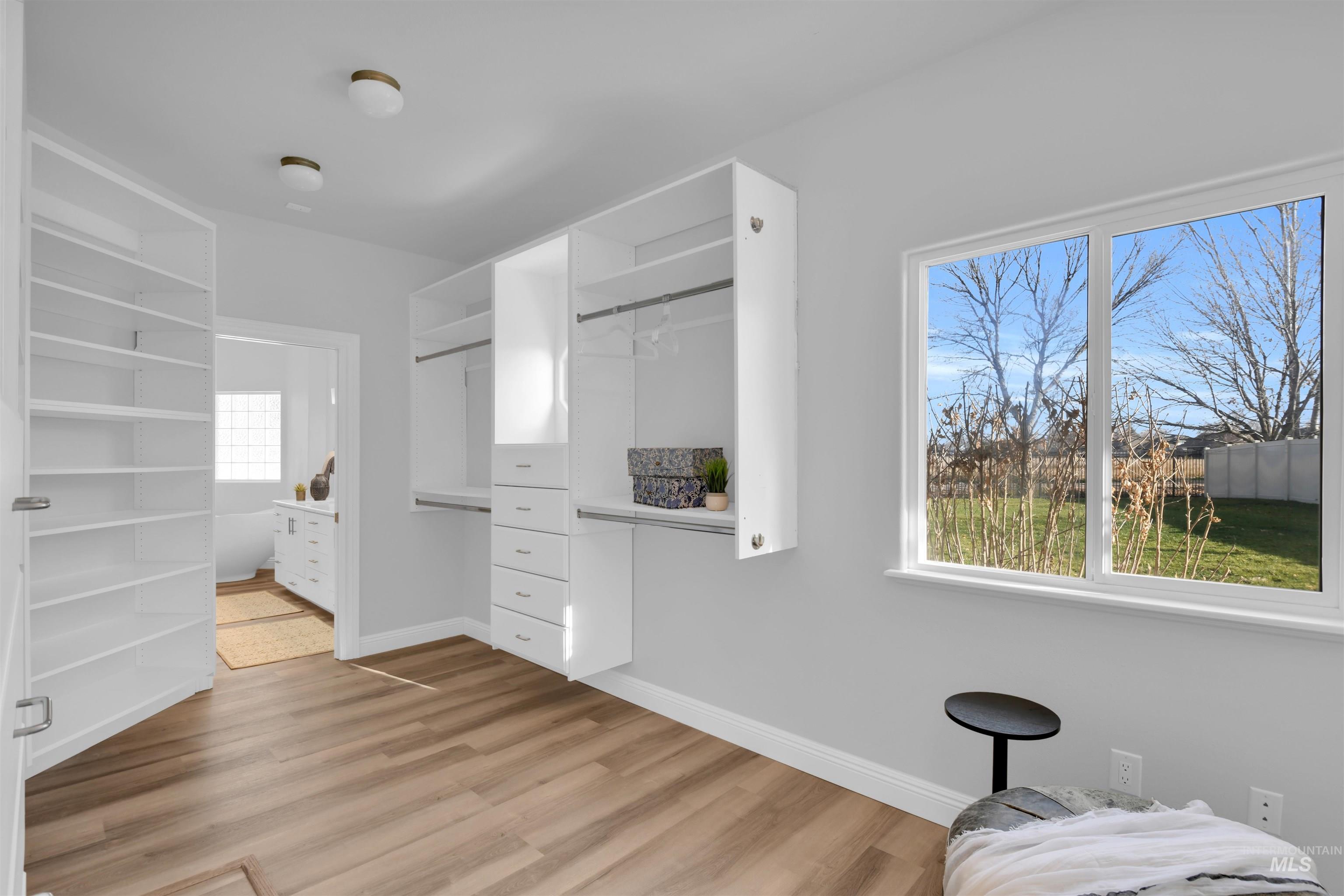 Spacious closet featuring light wood-type flooring