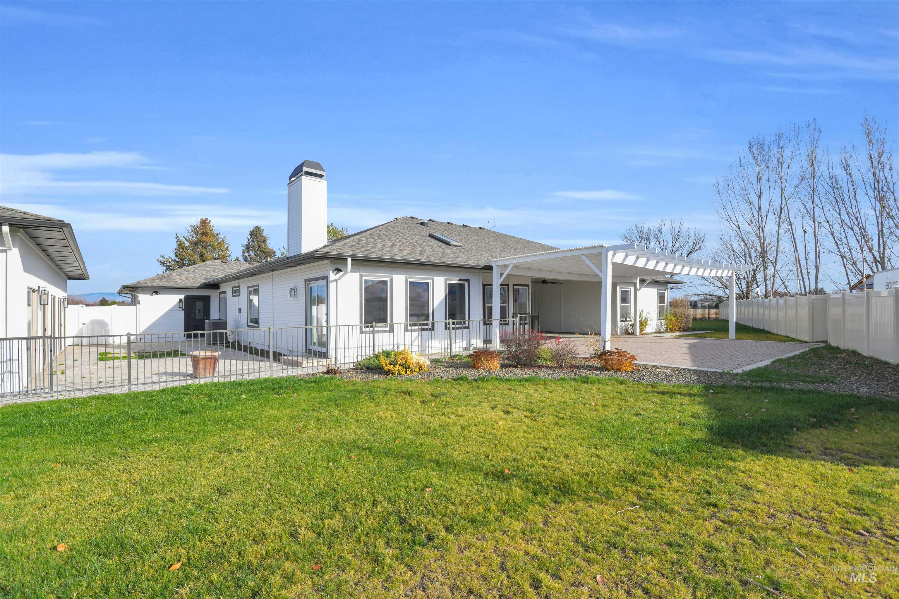 Back of property with a patio area, a fenced backyard, a chimney, roof with shingles, and a pergola