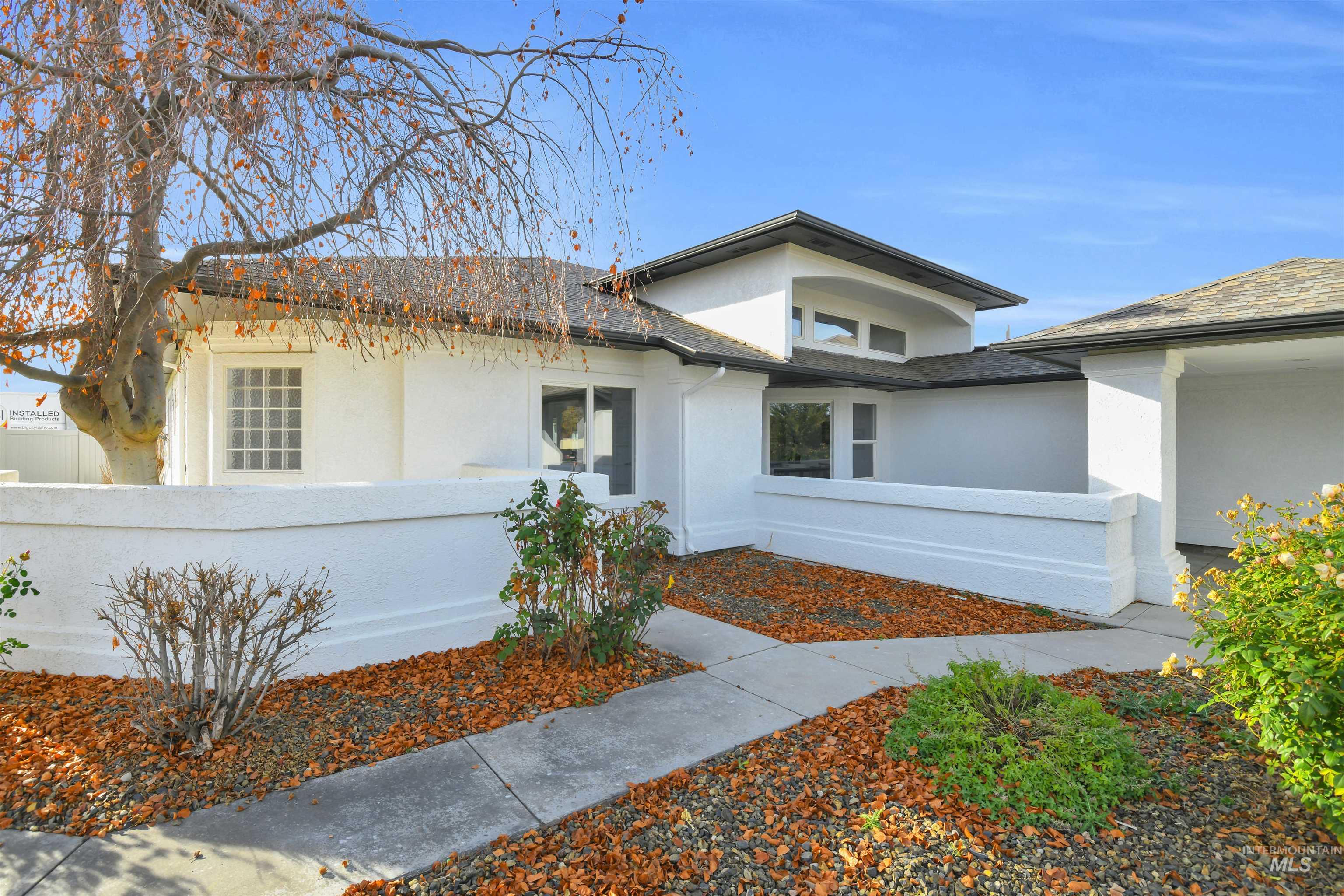 View of front of property with stucco siding and a fenced front yard
