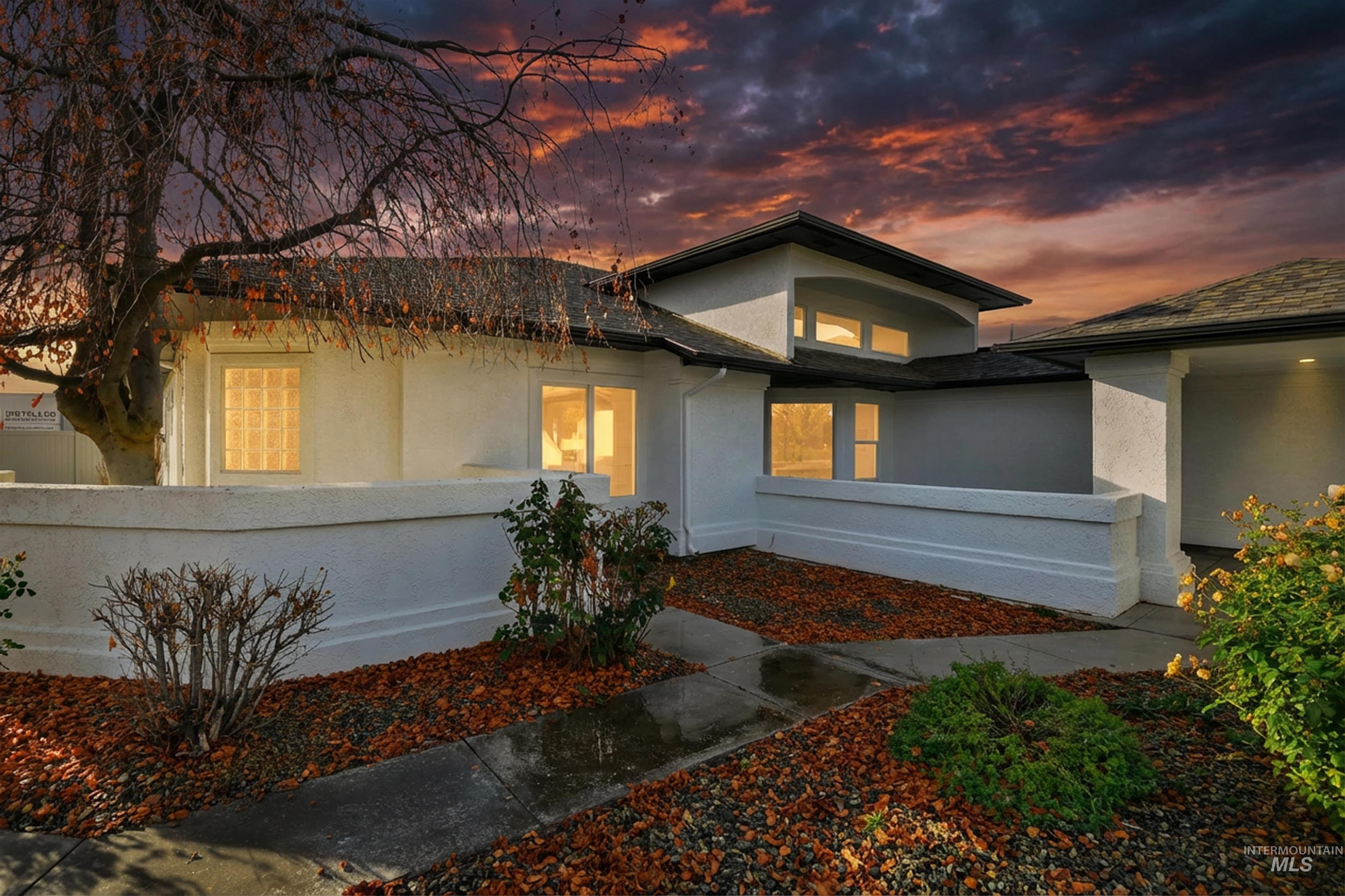 Modern home with stucco siding and a fenced front yard