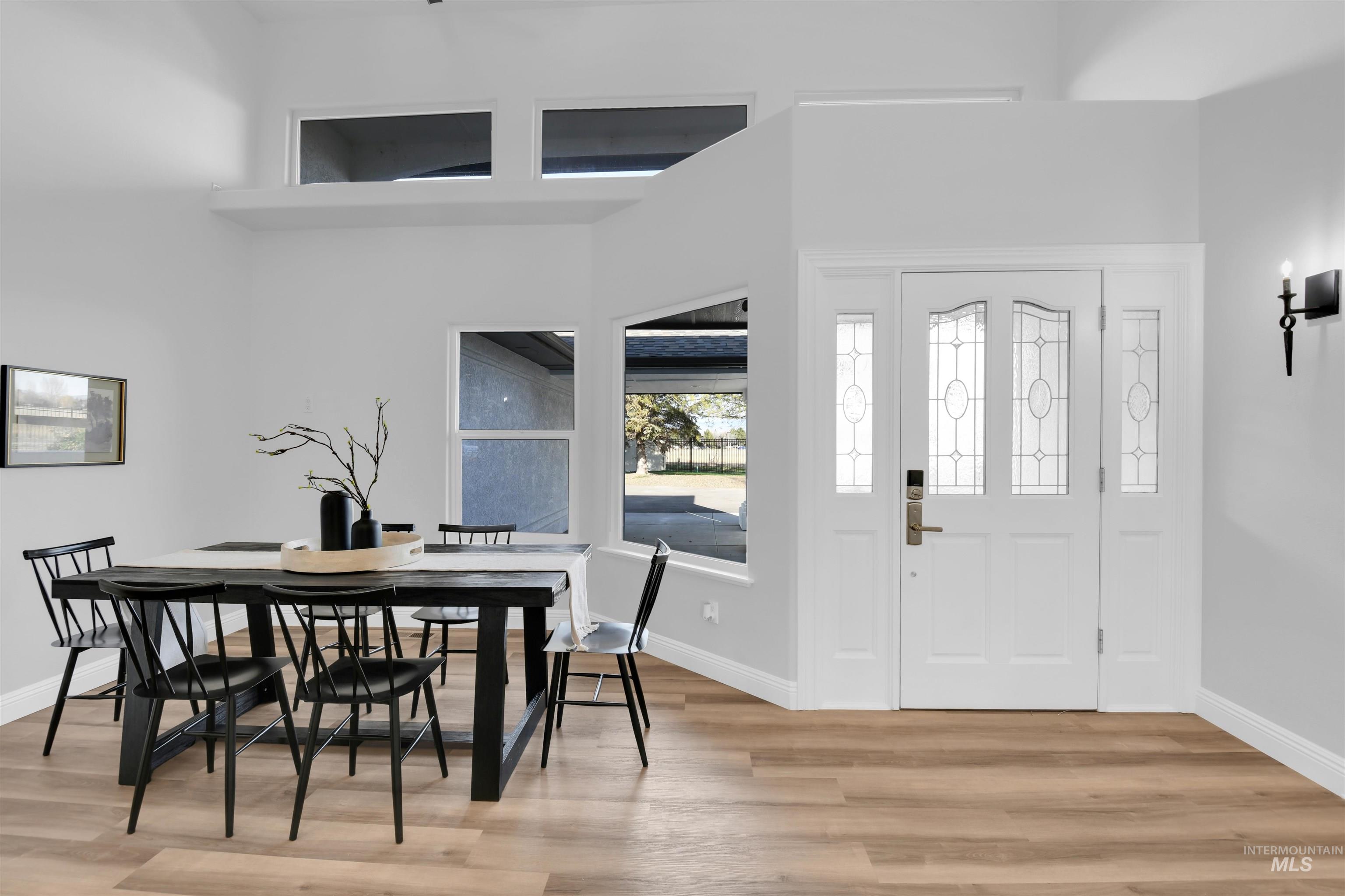 Foyer featuring light wood-style flooring and baseboards