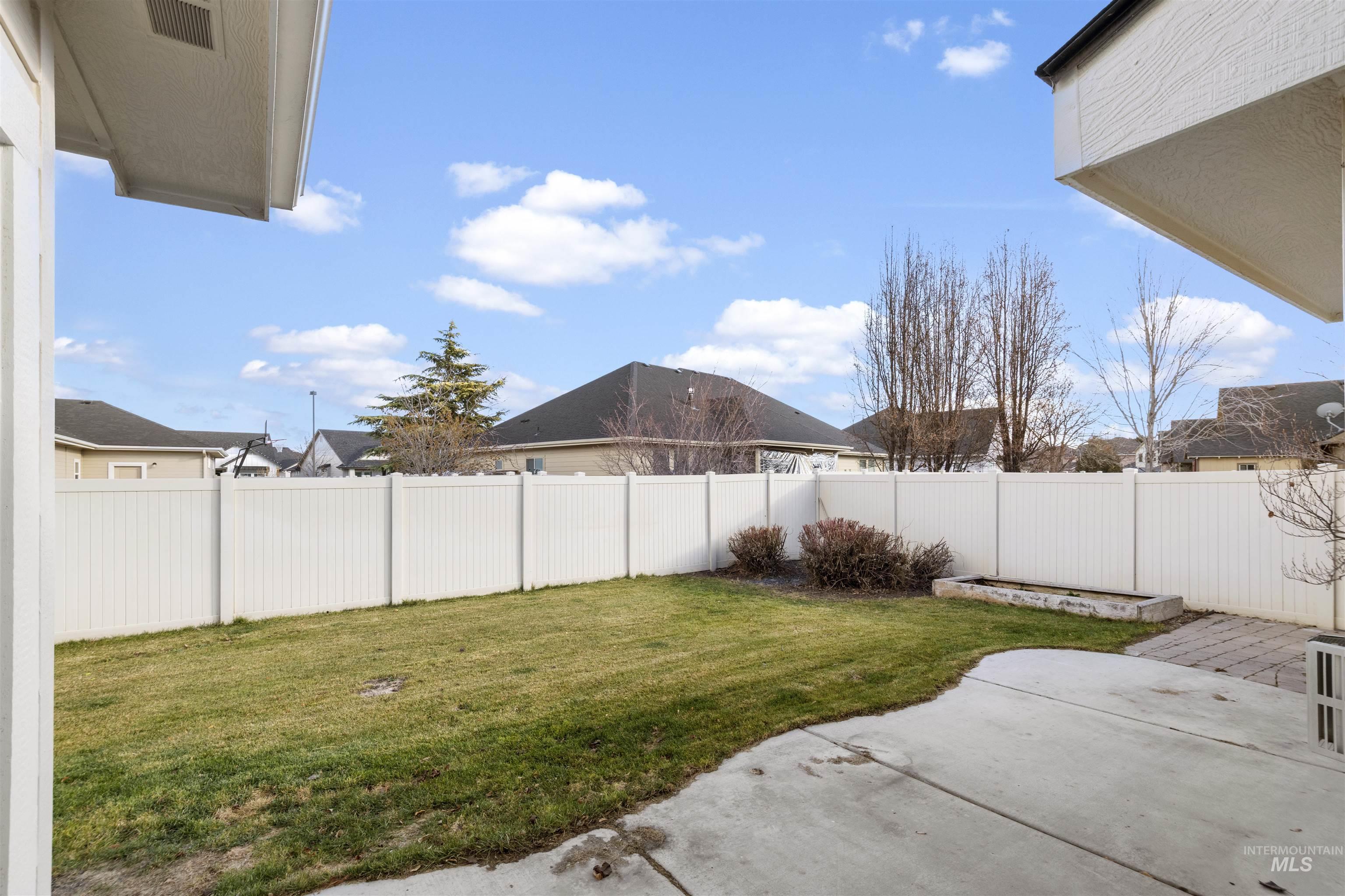 Fenced backyard with a patio area