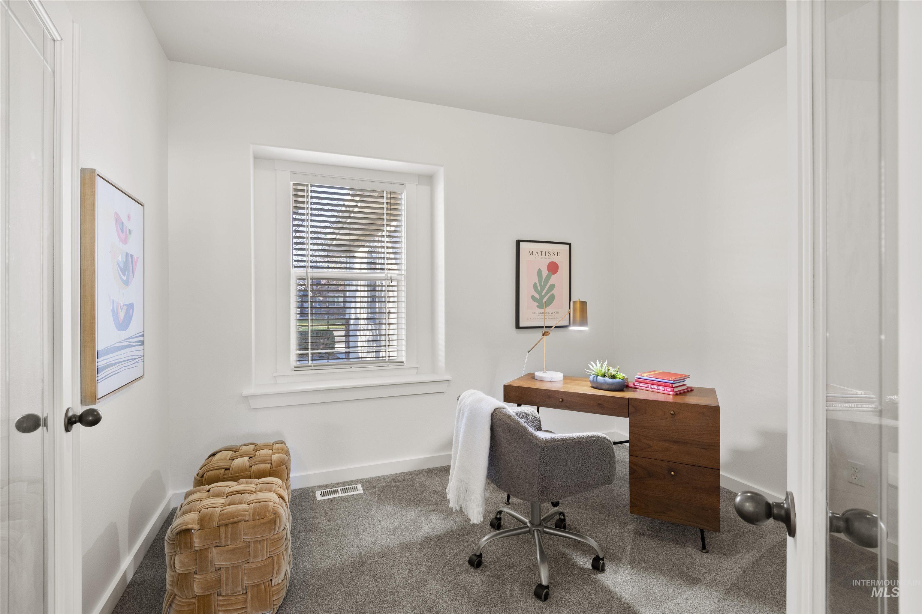 Carpeted home office featuring baseboards and french doors