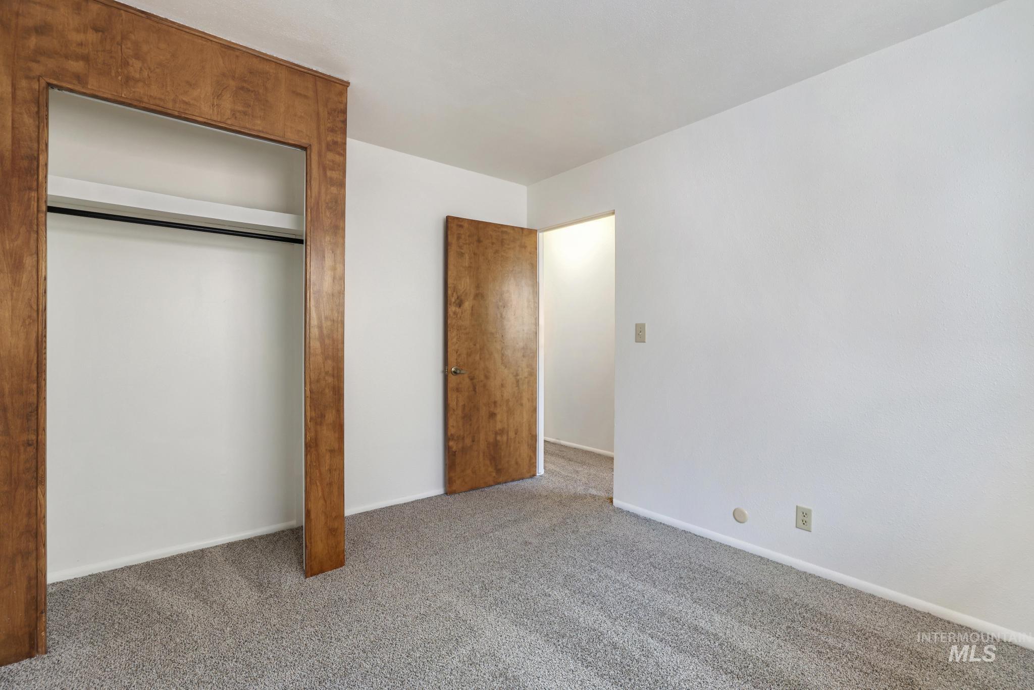 Unfurnished bedroom featuring carpet and a closet