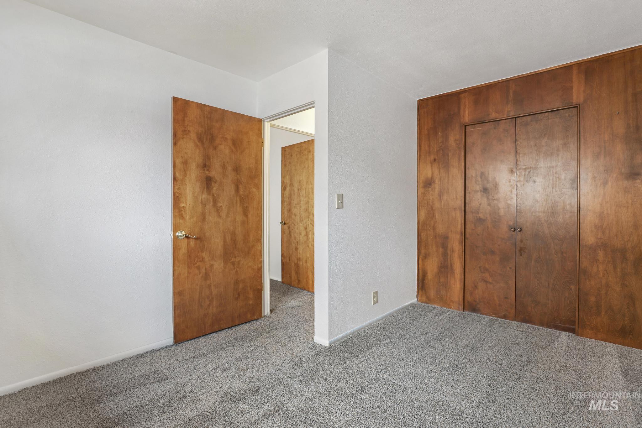 Unfurnished bedroom featuring a closet and carpet floors