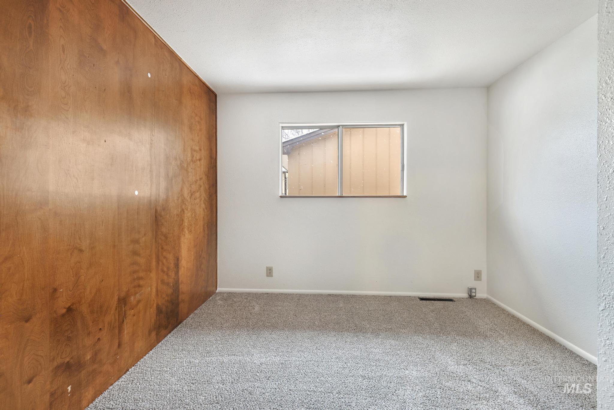 Unfurnished bedroom featuring carpet and baseboards