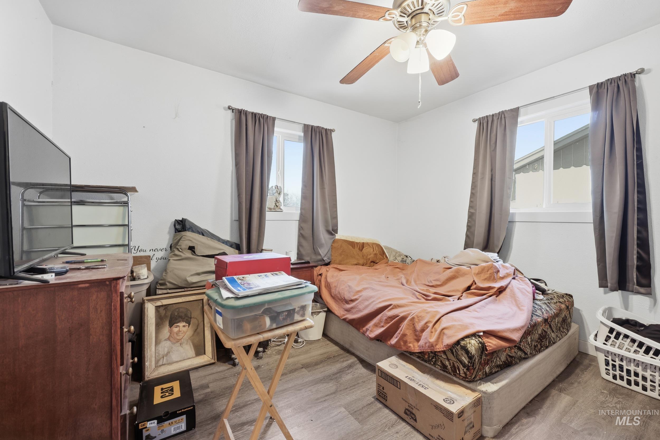 Bedroom with wood finished floors and a ceiling fan