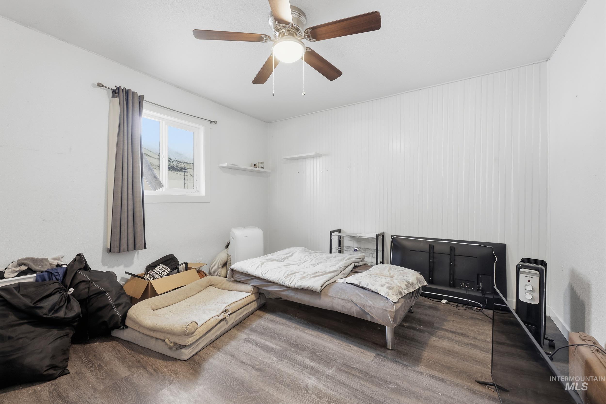 Bedroom with wood finished floors and ceiling fan