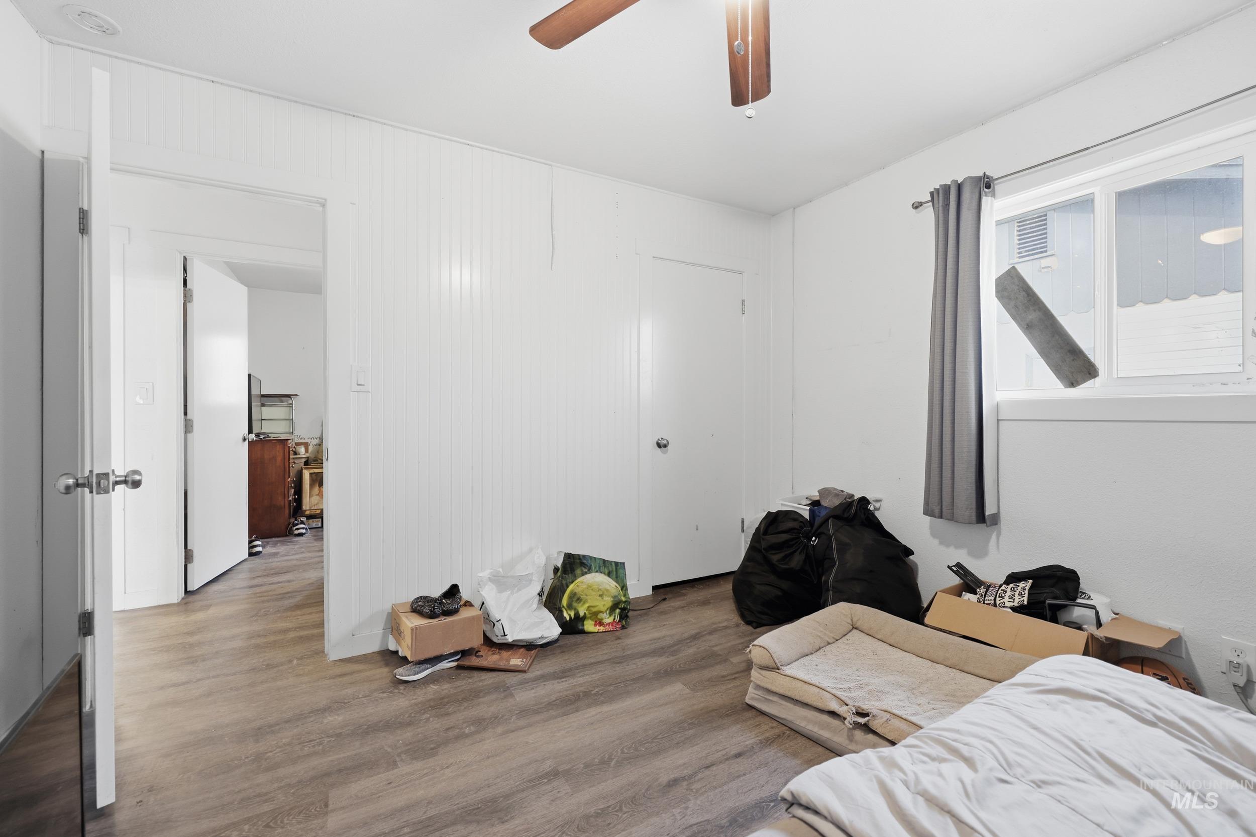 Bedroom featuring wood finished floors and a ceiling fan