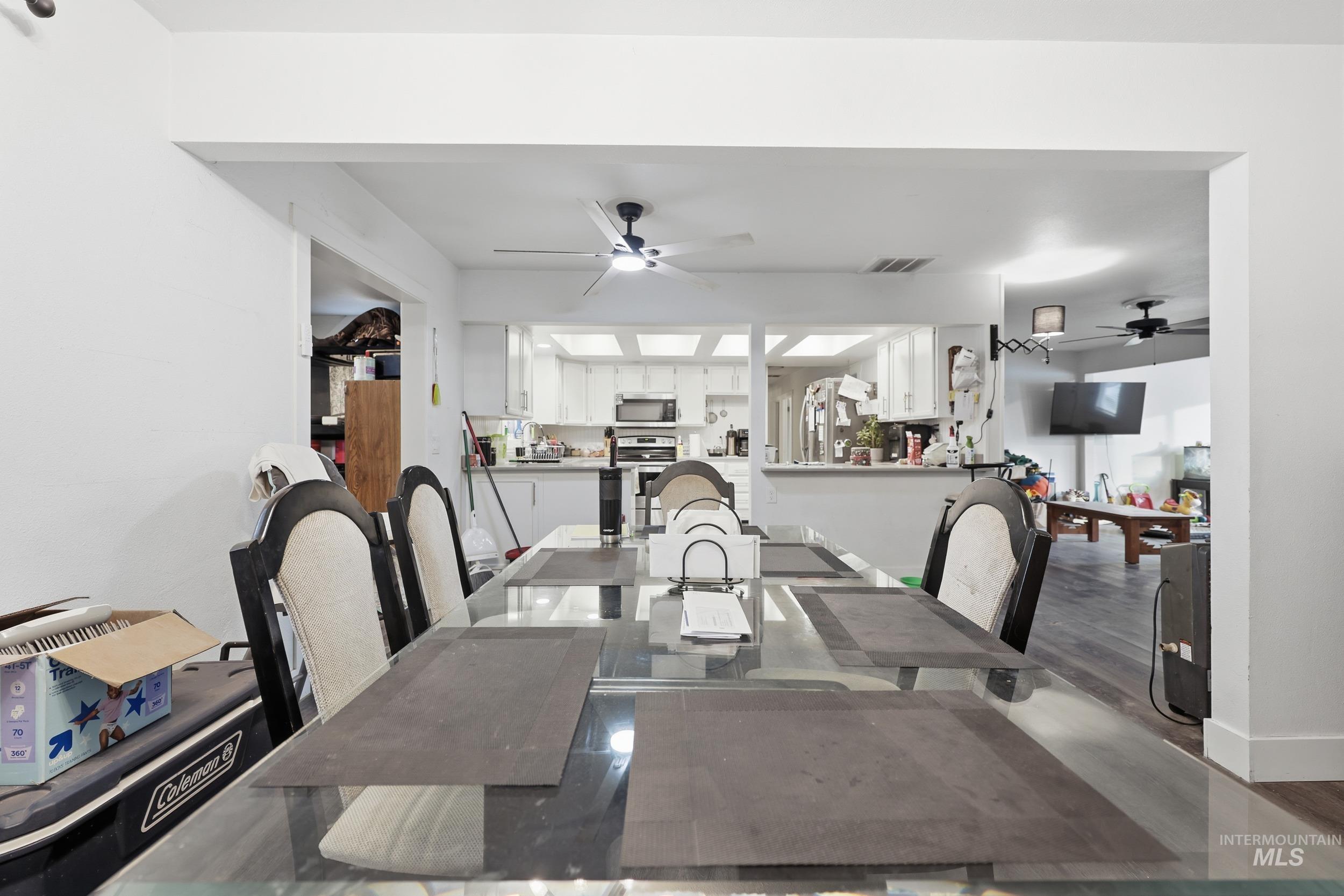 Dining area featuring wood finished floors and a ceiling fan