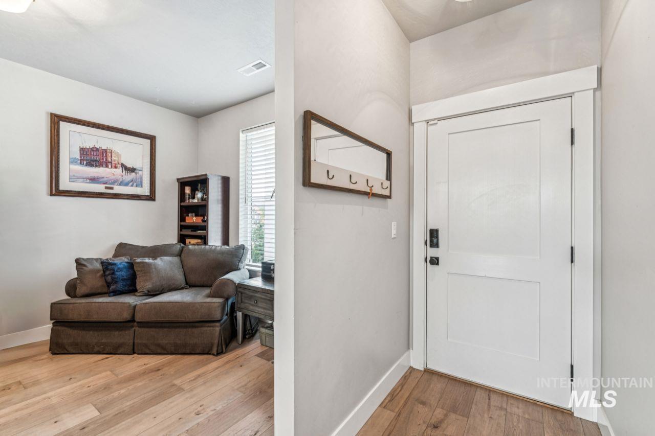 Entryway with light wood-style floors and baseboards