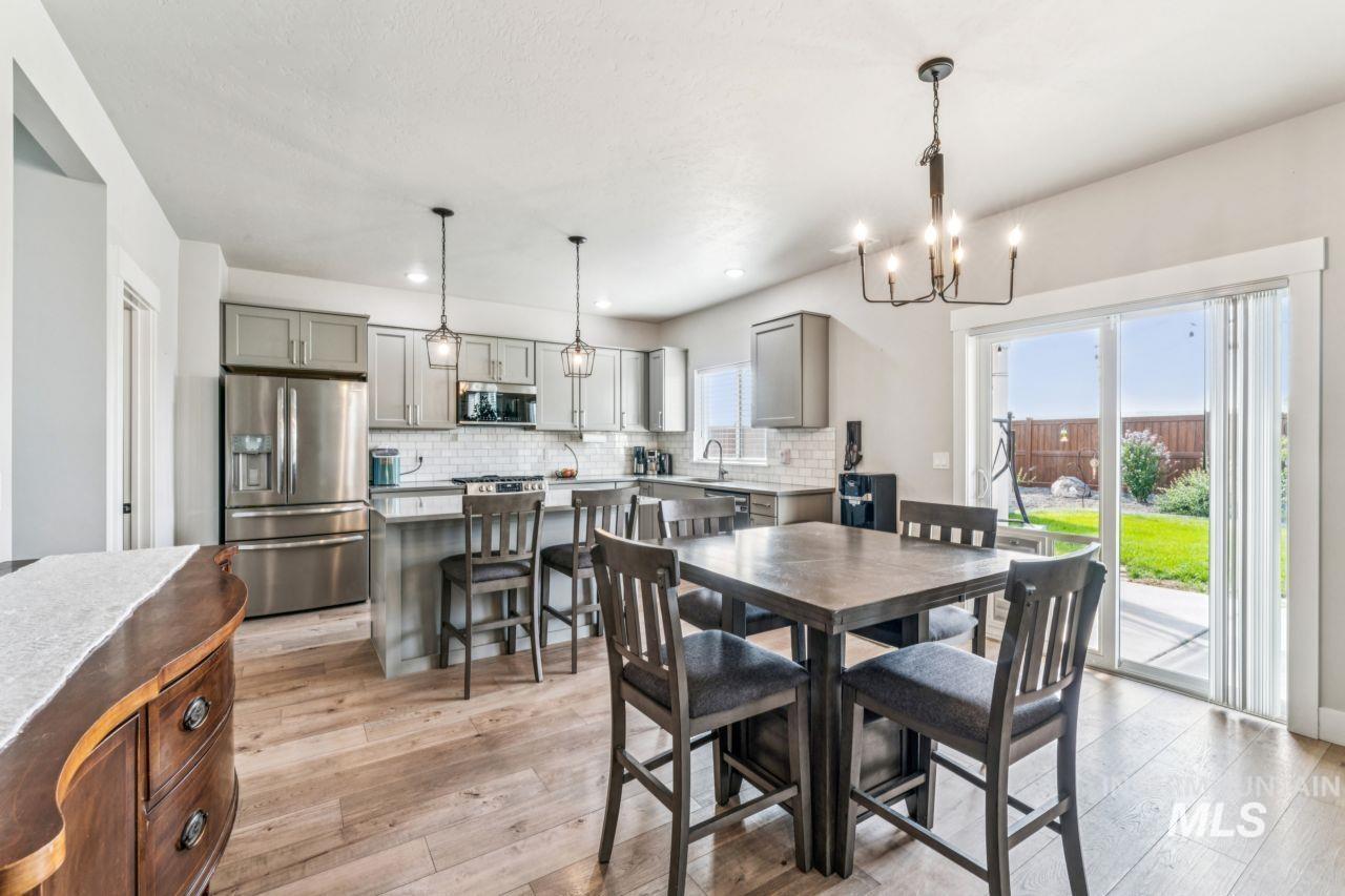 Dining room featuring a chandelier, light wood-type flooring, plenty of natural light, and recessed lighting