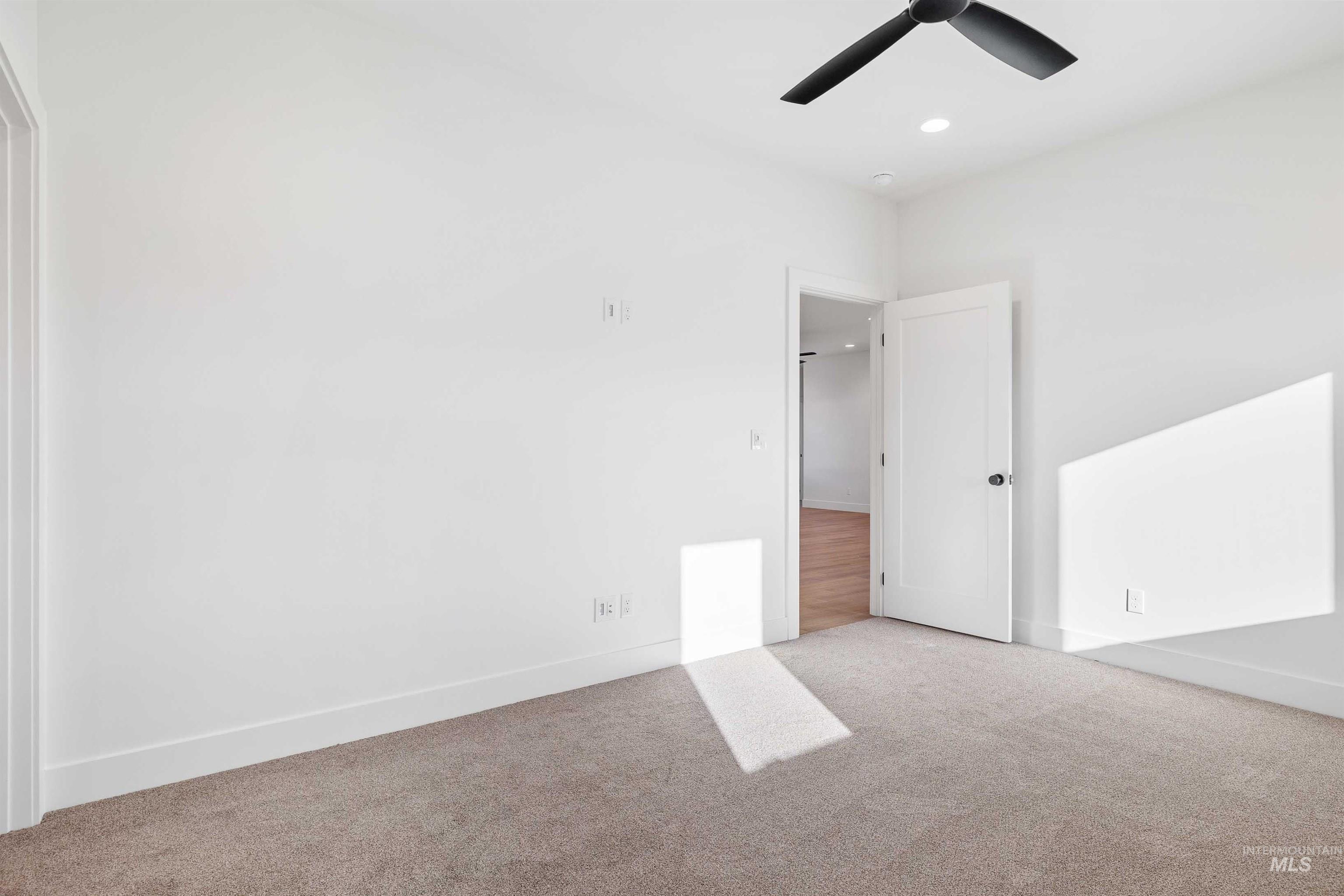 Unfurnished bedroom featuring carpet floors, recessed lighting, and a ceiling fan