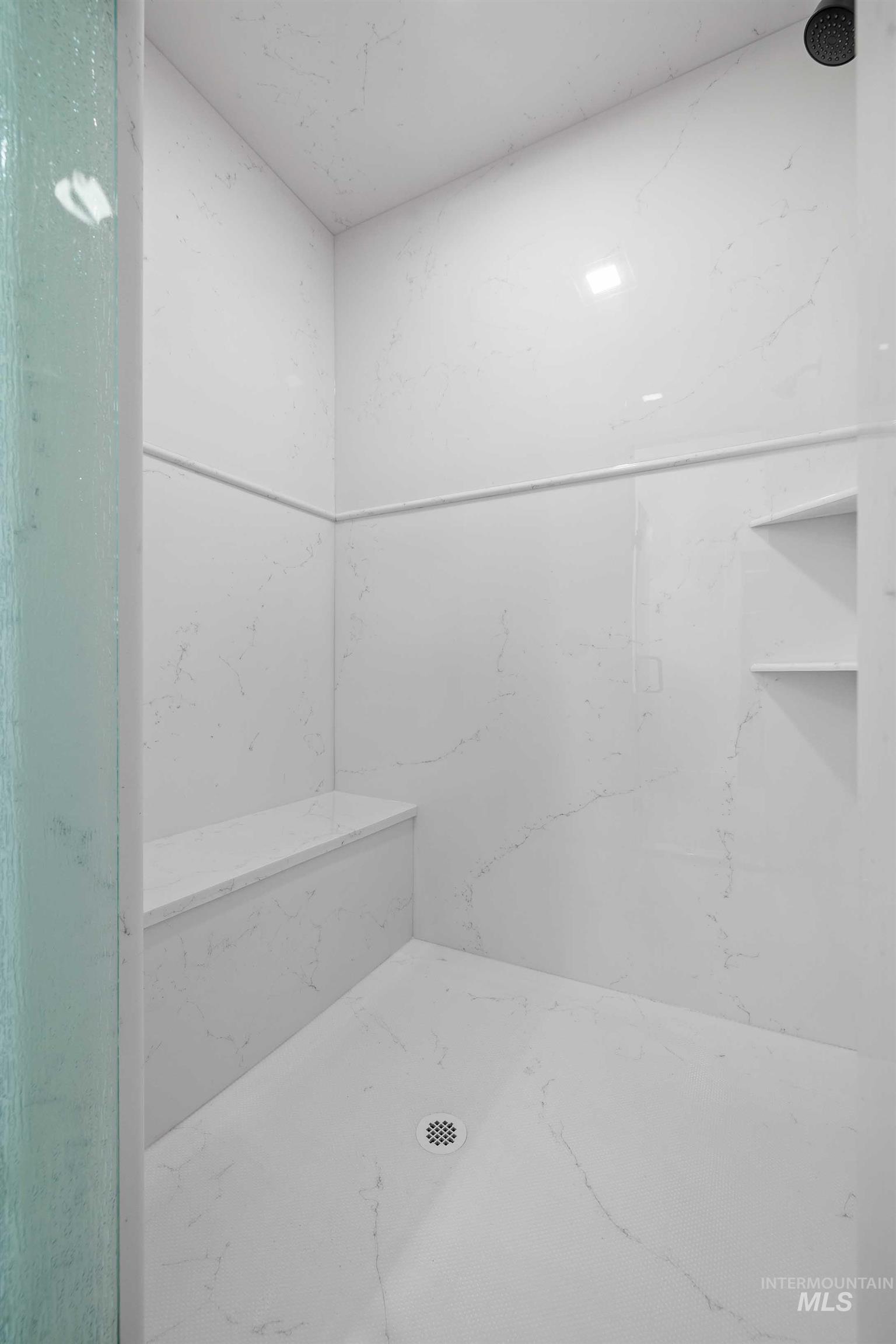 Bathroom with a marble finish shower