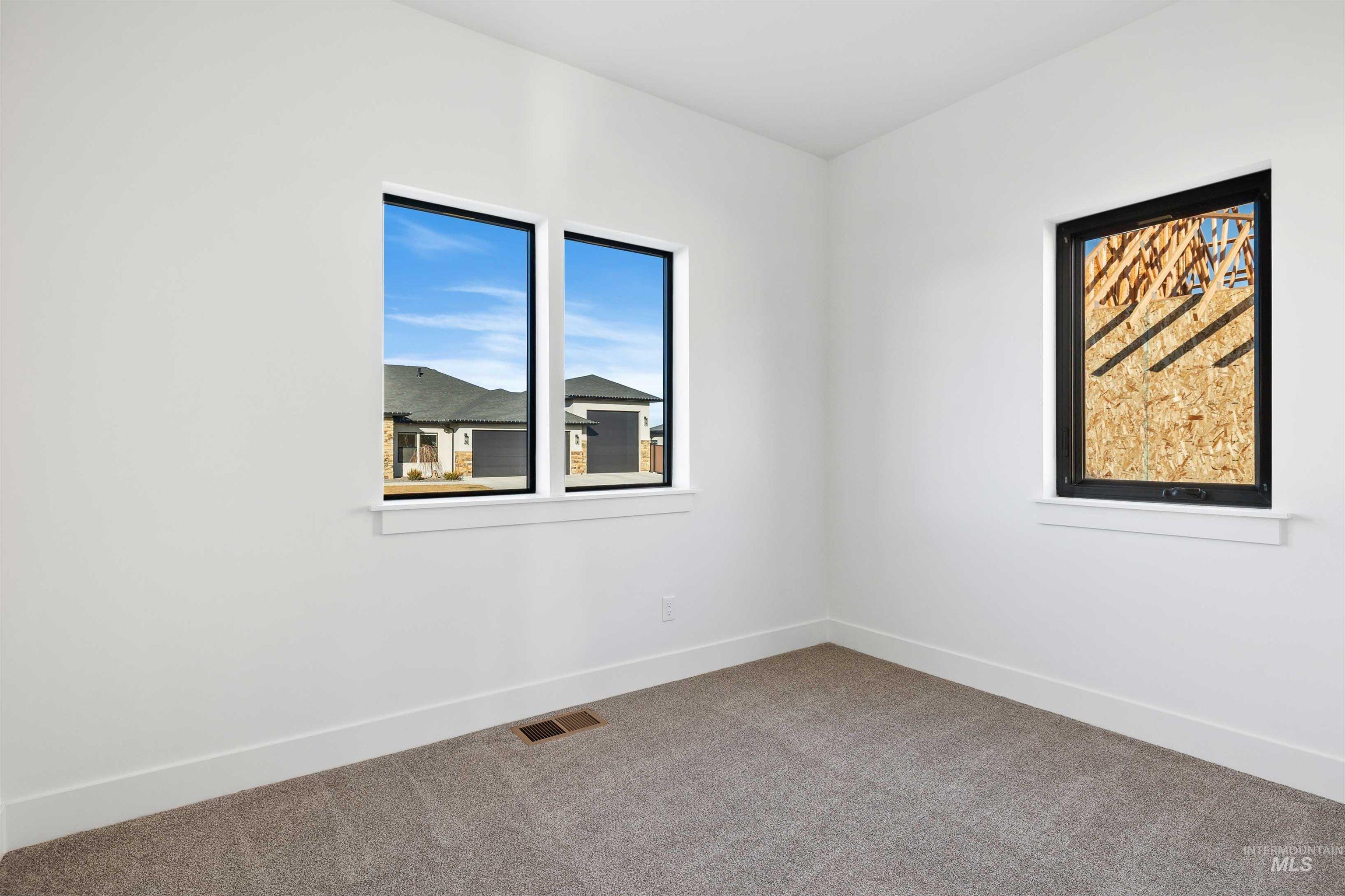 Carpeted empty room with baseboards