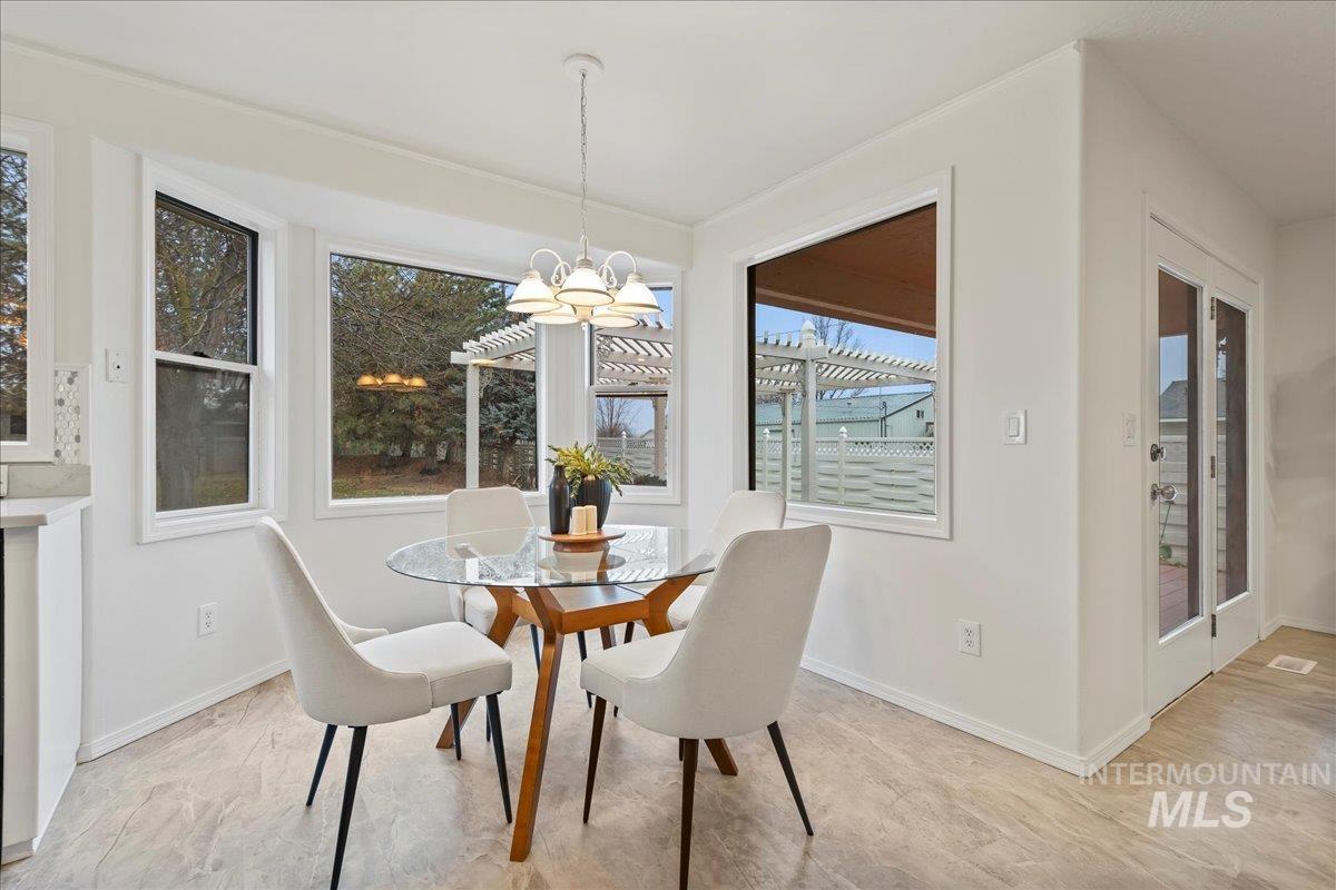 Dining space with a chandelier and baseboards