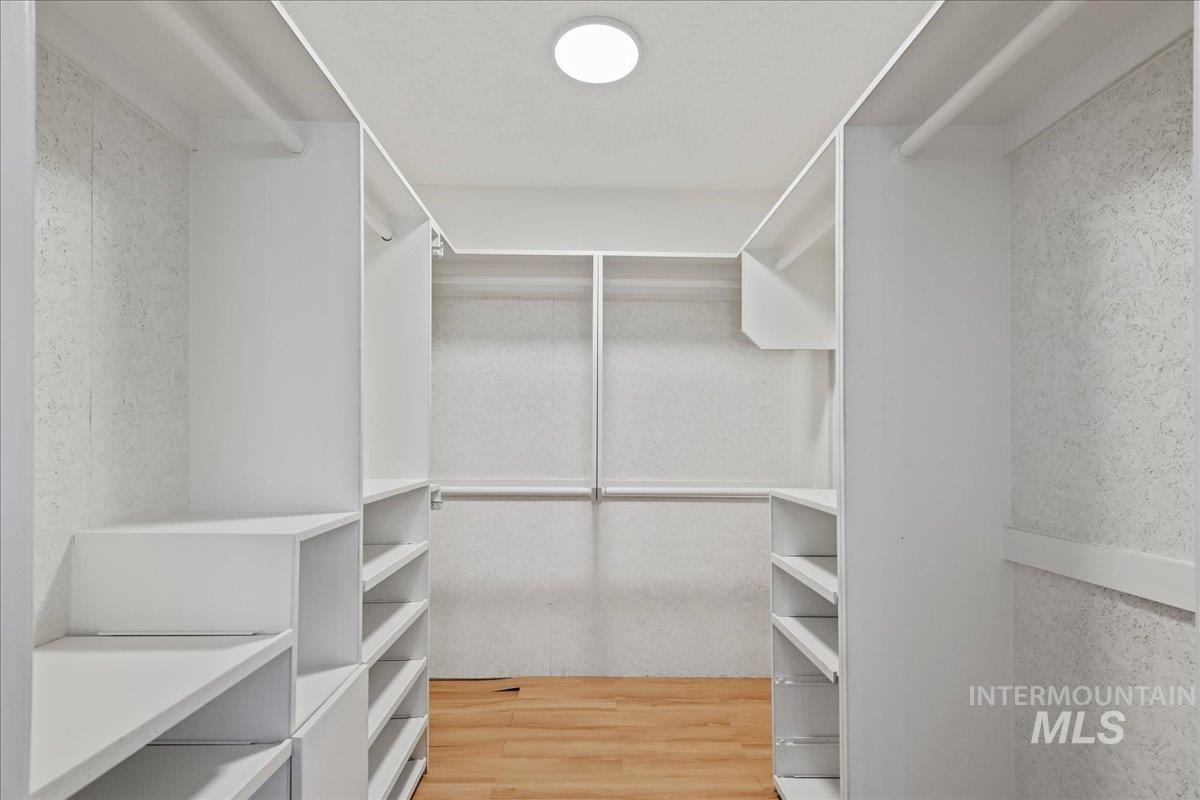 Spacious closet featuring light wood-style floors