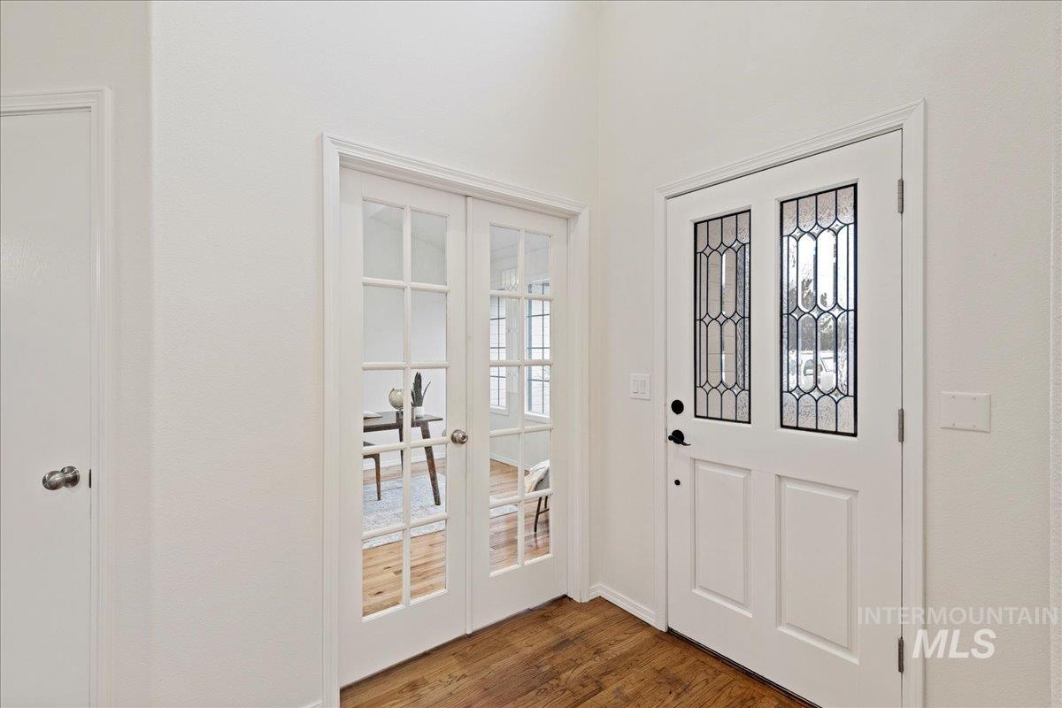 Entrance foyer featuring french doors and dark wood-type flooring