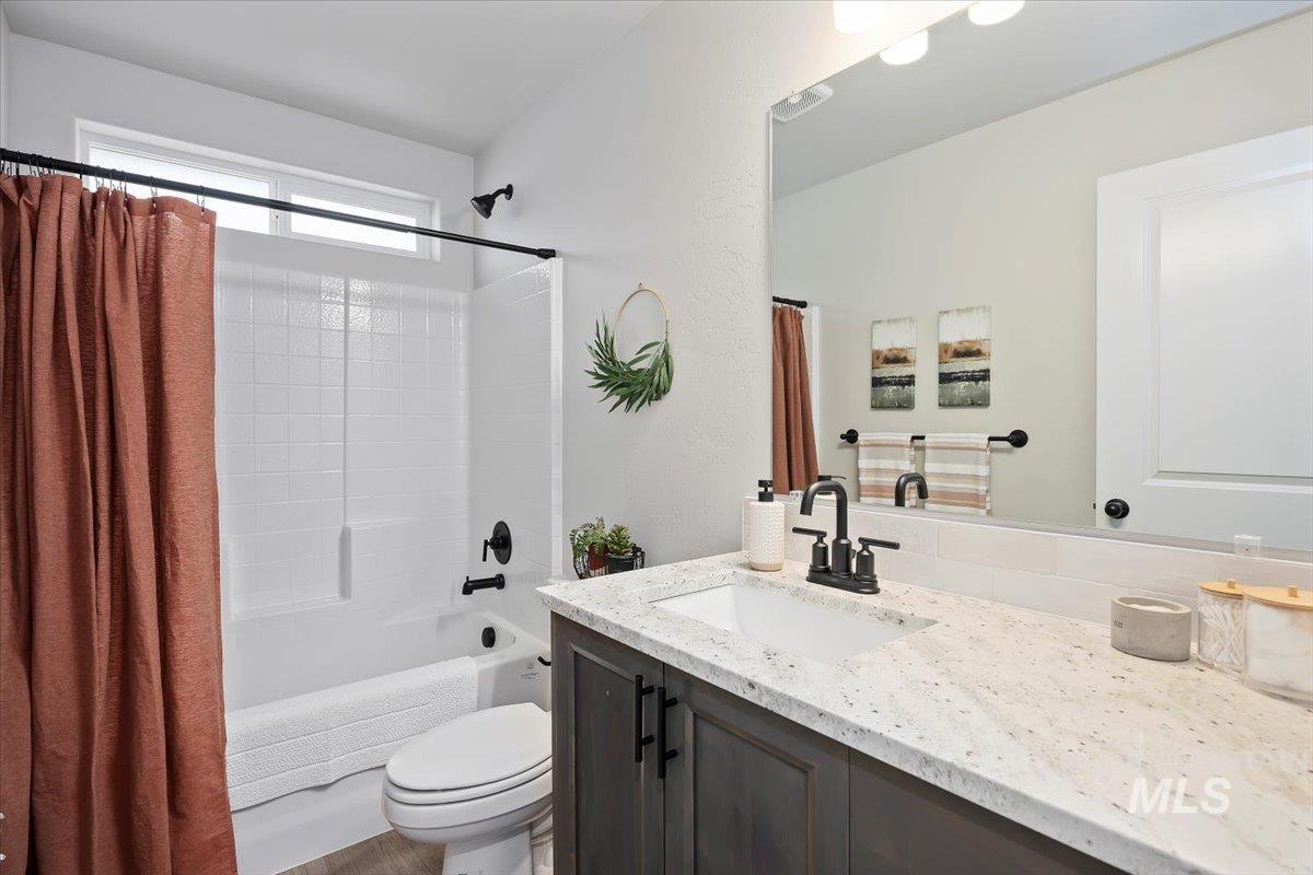 Bathroom featuring shower / tub combo and vanity