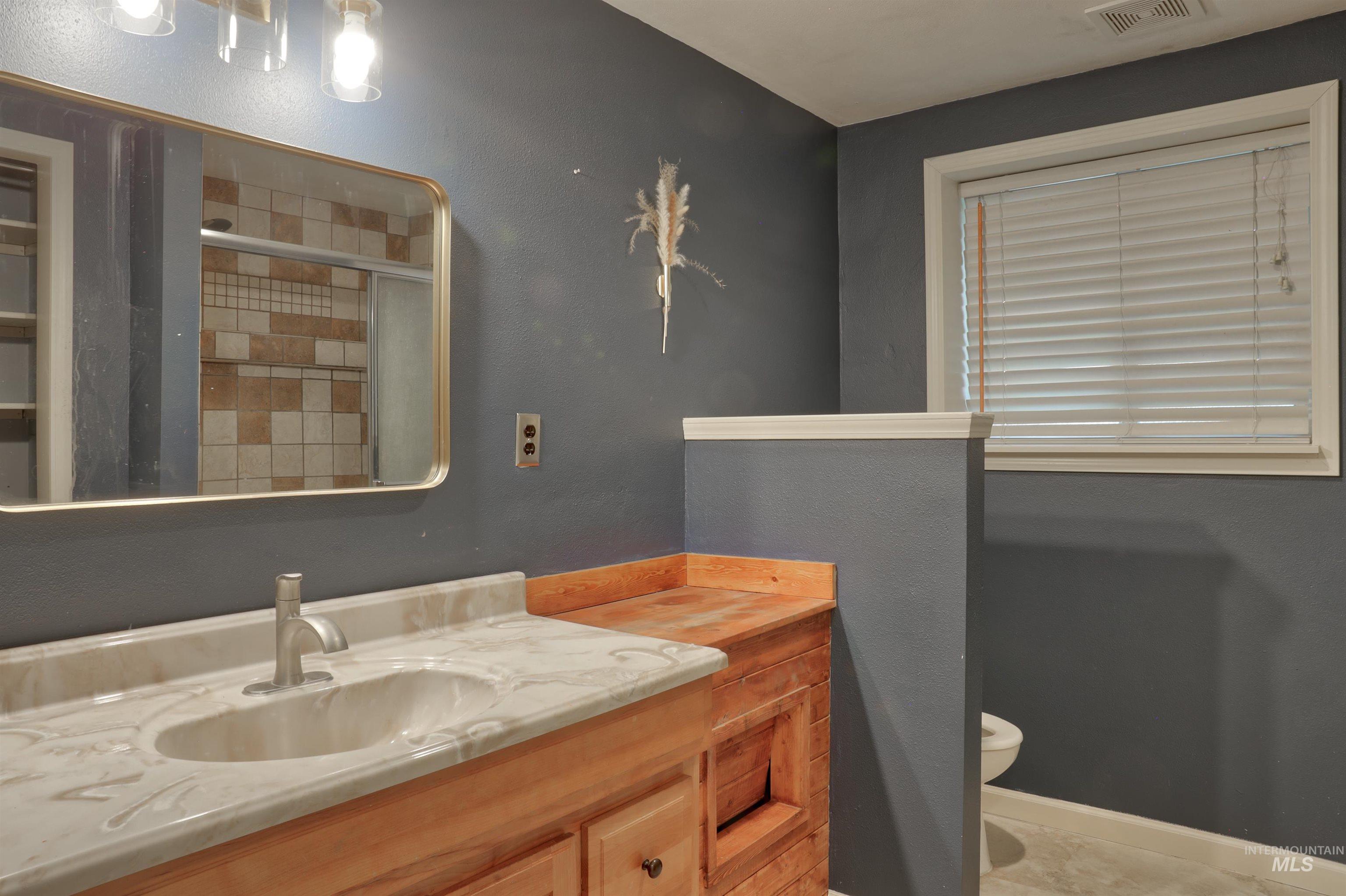 Bathroom with a shower stall and vanity
