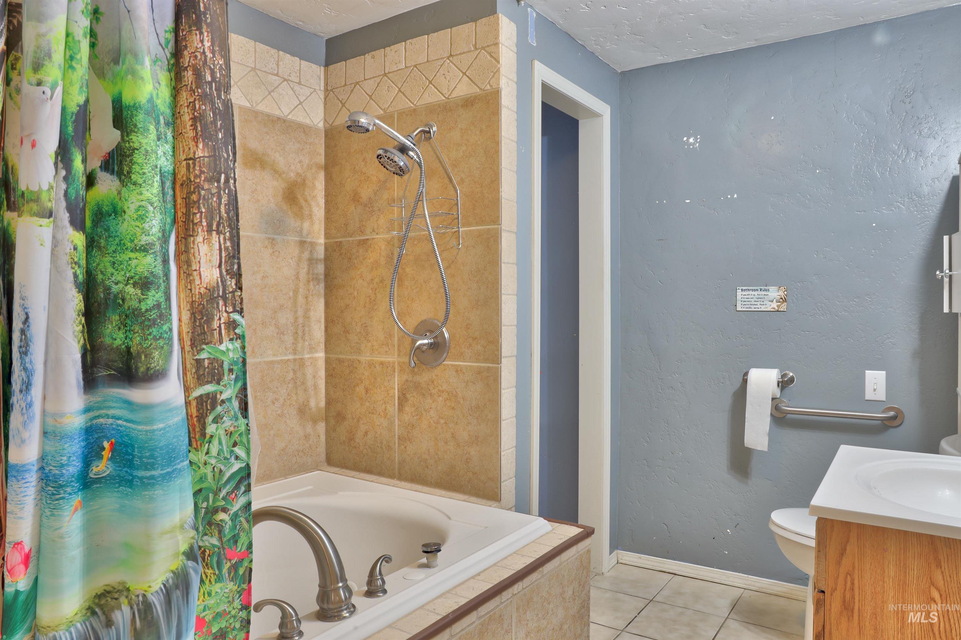 Full bathroom featuring tiled shower & jacuzzi tub.