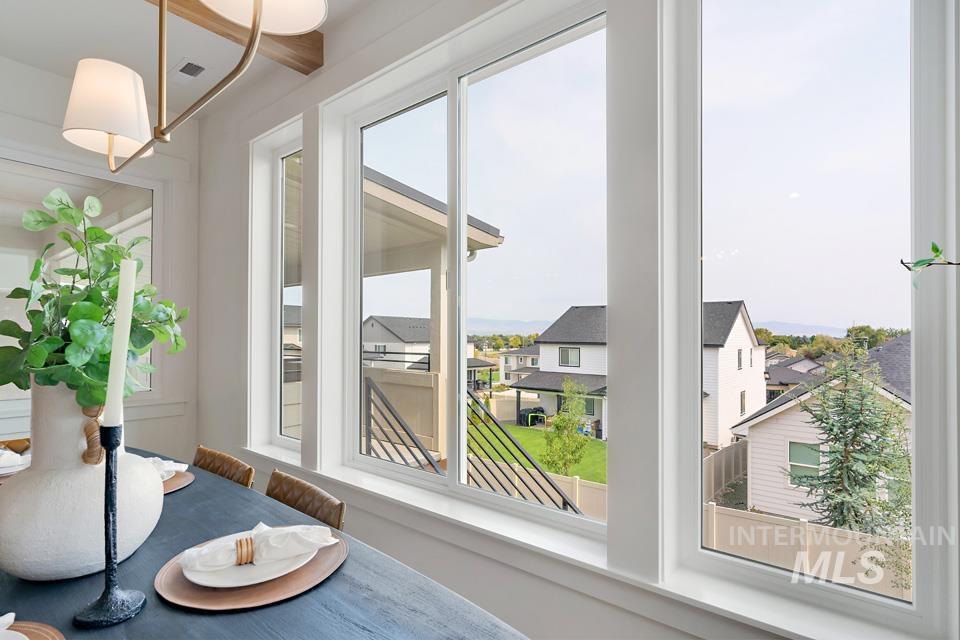 Sunroom / solarium featuring healthy amount of natural light and a residential view