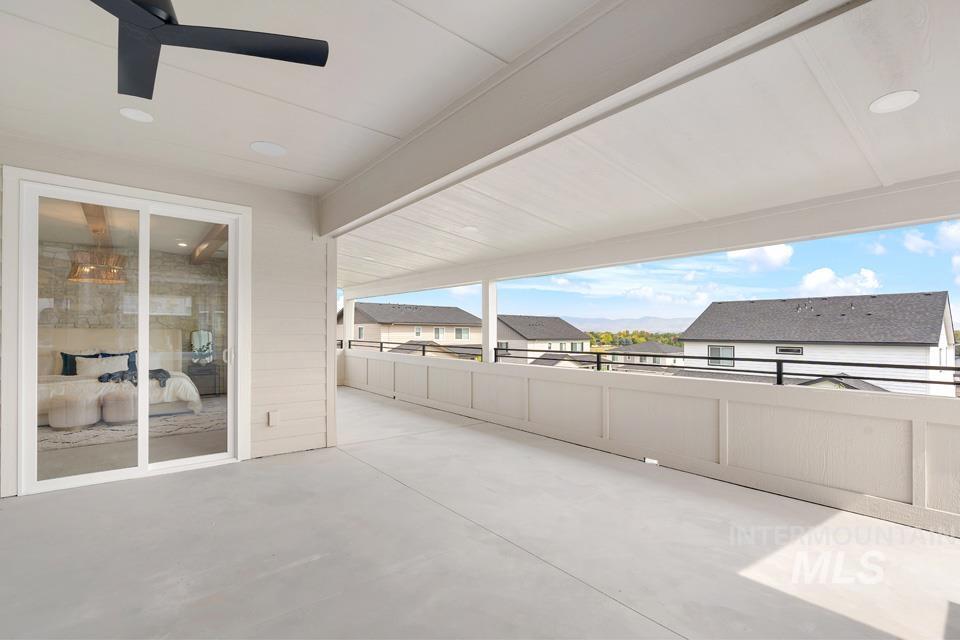View of patio with ceiling fan and a residential view