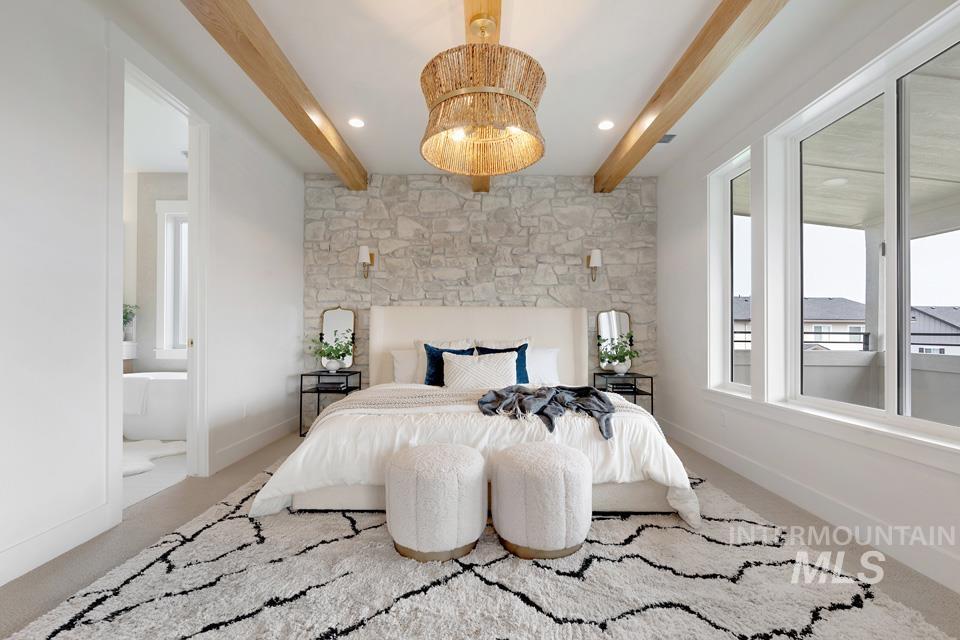 Carpeted bedroom featuring beam ceiling, a chandelier, ensuite bath, and recessed lighting