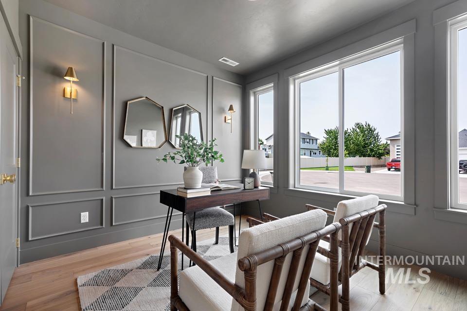 Office featuring a decorative wall and light wood finished floors