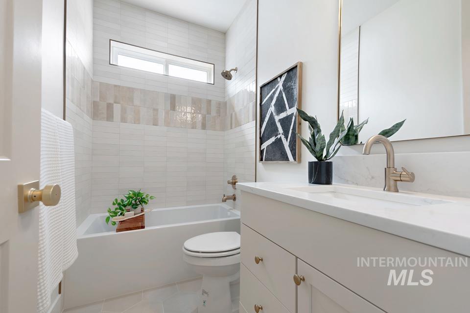 Bathroom with shower / tub combo with curtain, vanity, and light tile patterned floors