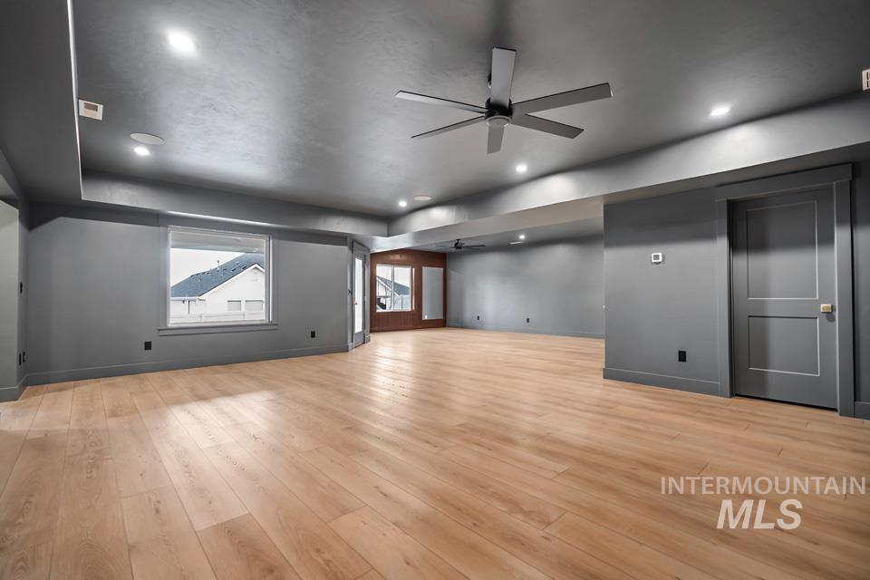 Unfurnished living room with ceiling fan, light wood finished floors, and recessed lighting