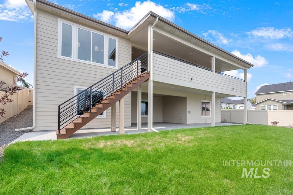 Back of house with a fenced backyard, a patio, stairway, and a deck