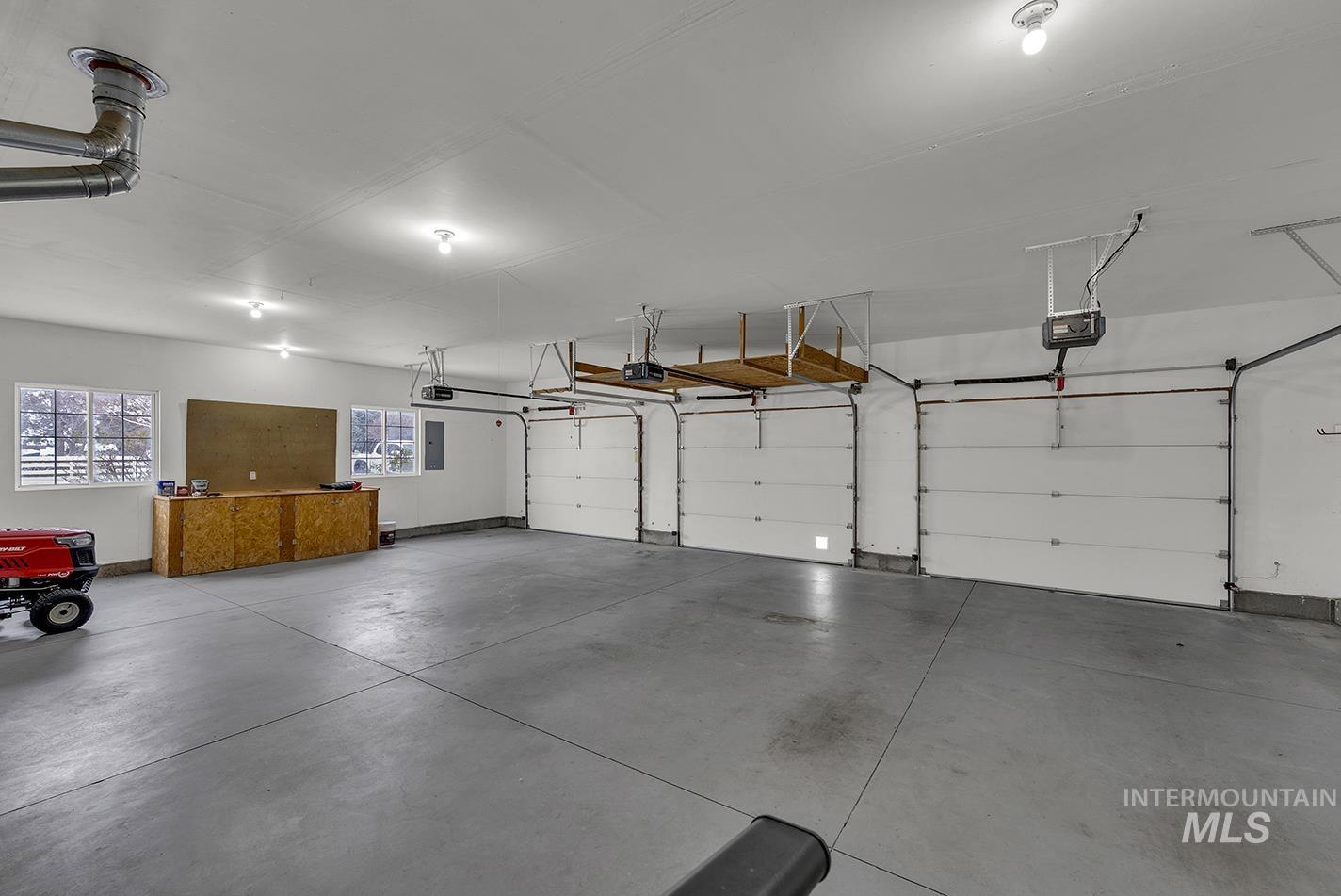 Garage with electric panel and a garage door opener