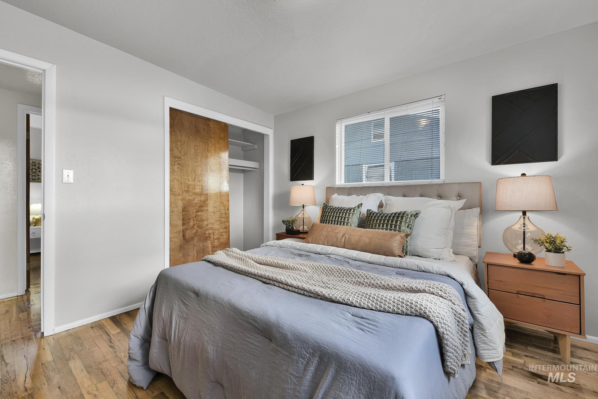 Bedroom with hardwood / wood-style floors and a closet