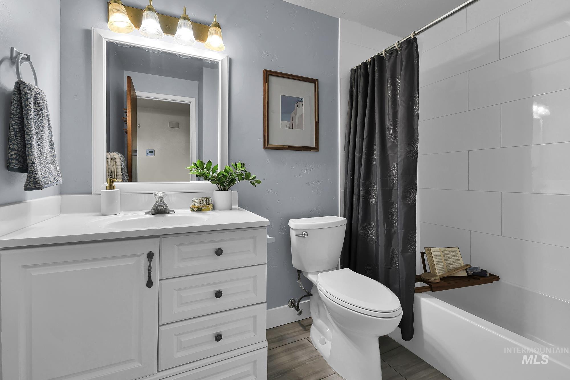 Full bathroom with vanity and shower / tub combo