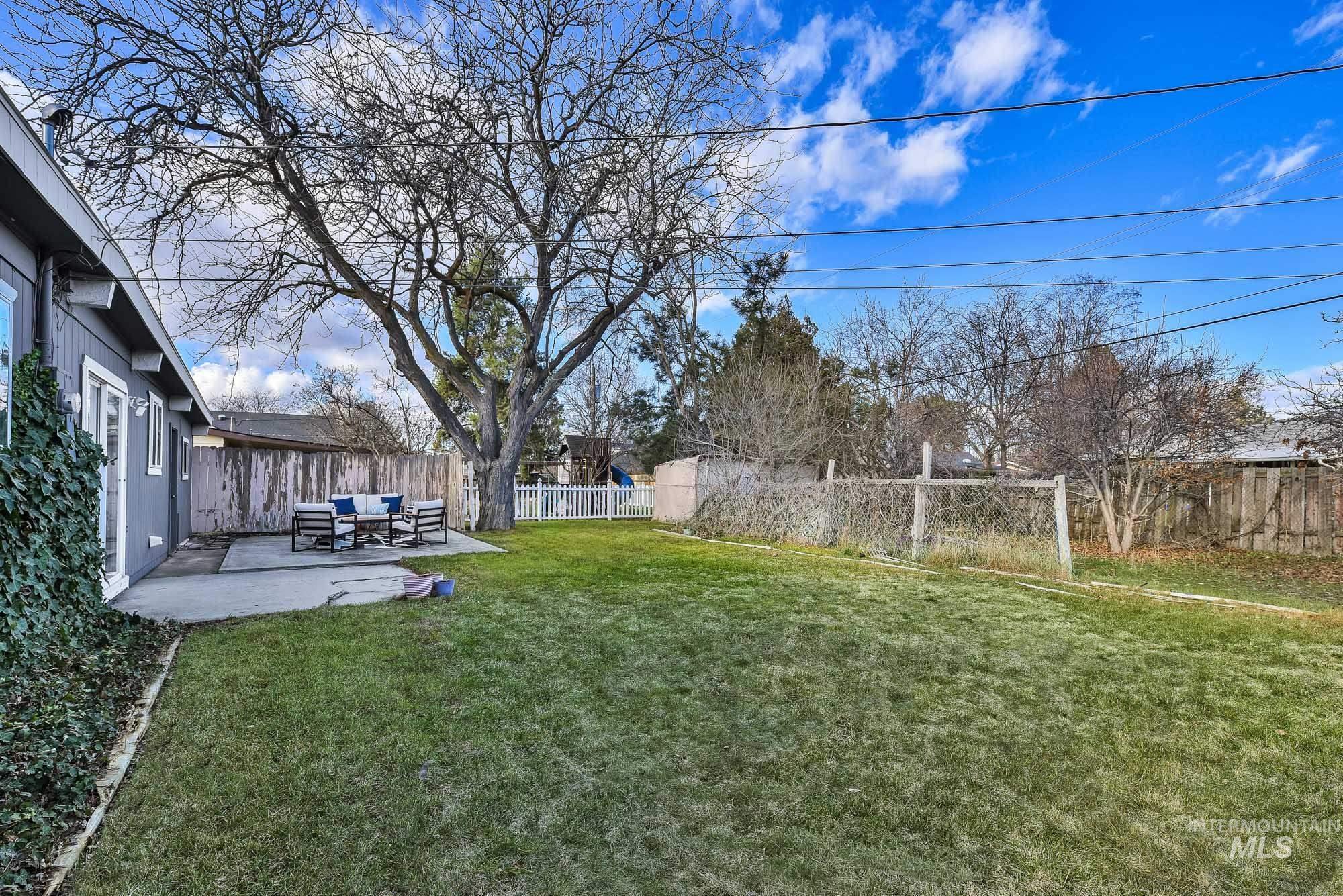 Fenced backyard featuring a patio and an outdoor hangout area