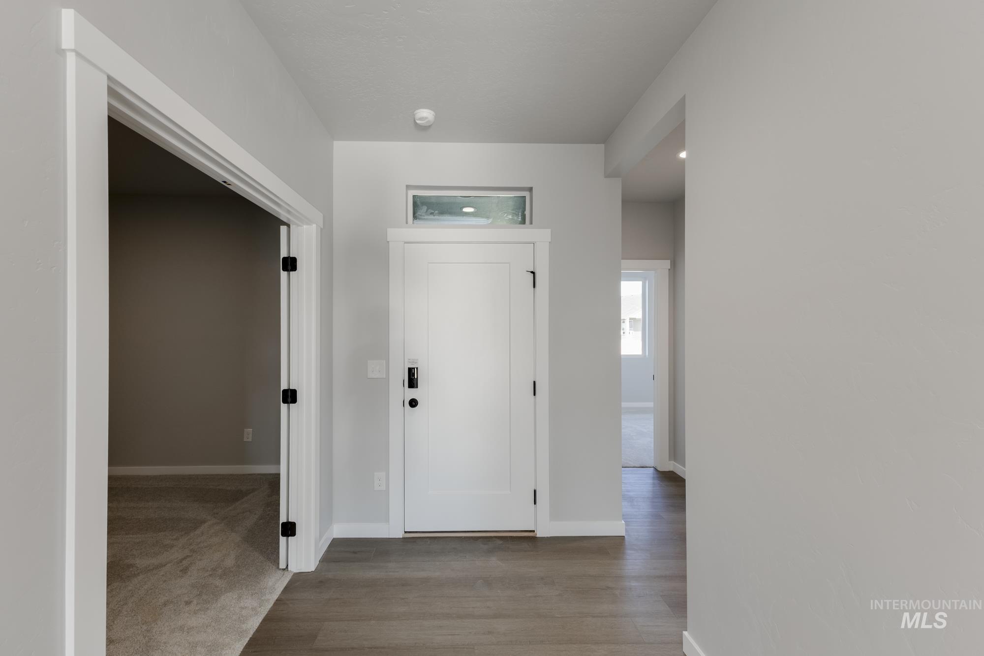 Foyer entrance featuring baseboards and light wood finished floors