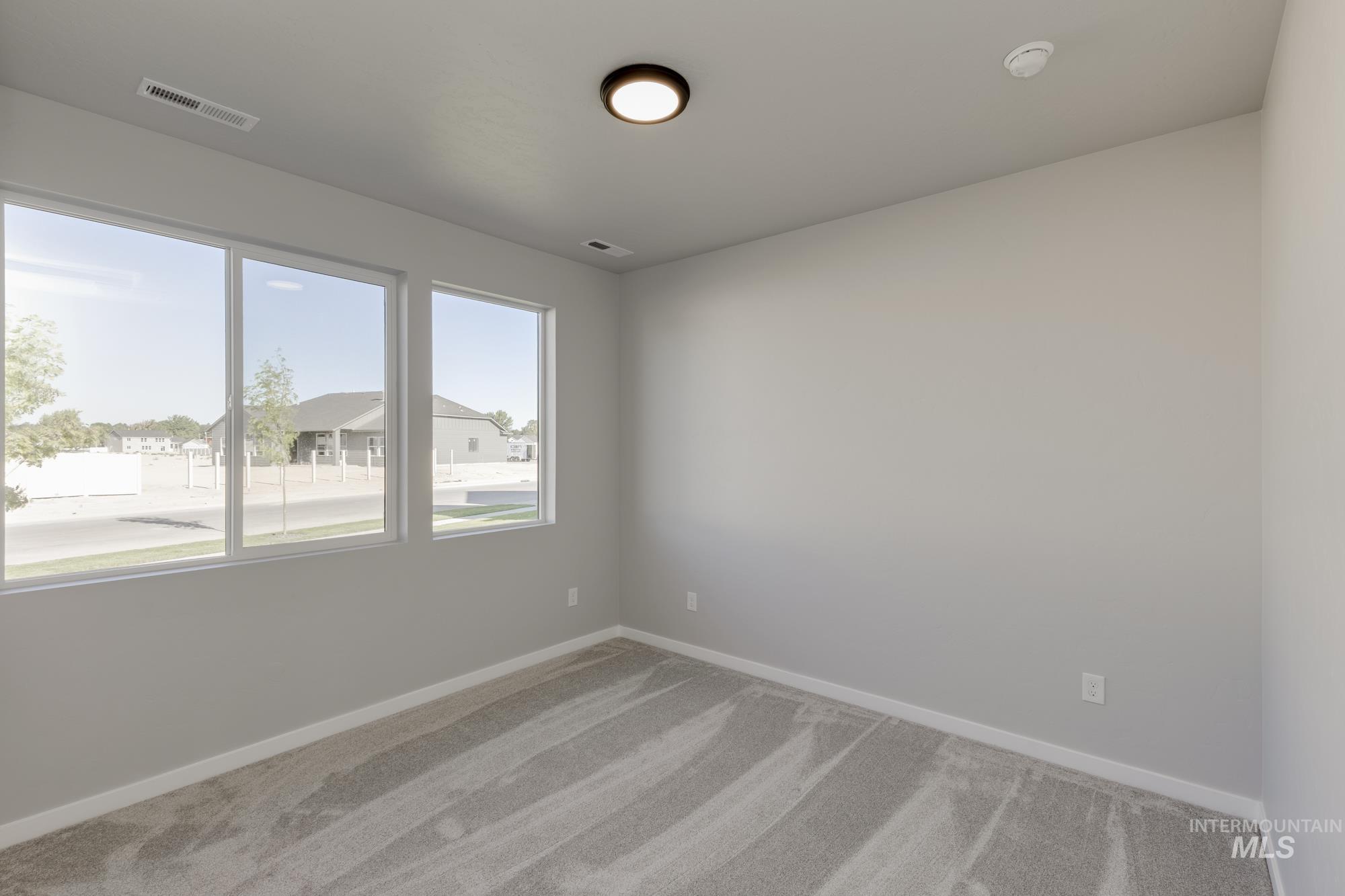 Spare room with carpet flooring and baseboards