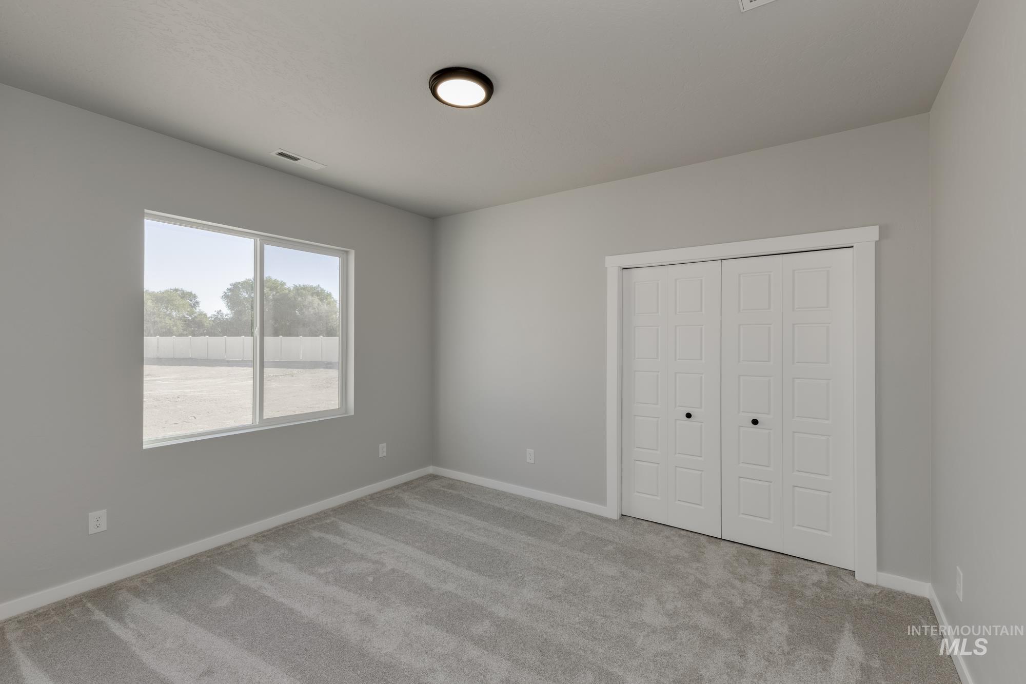 Unfurnished bedroom featuring carpet flooring and a closet