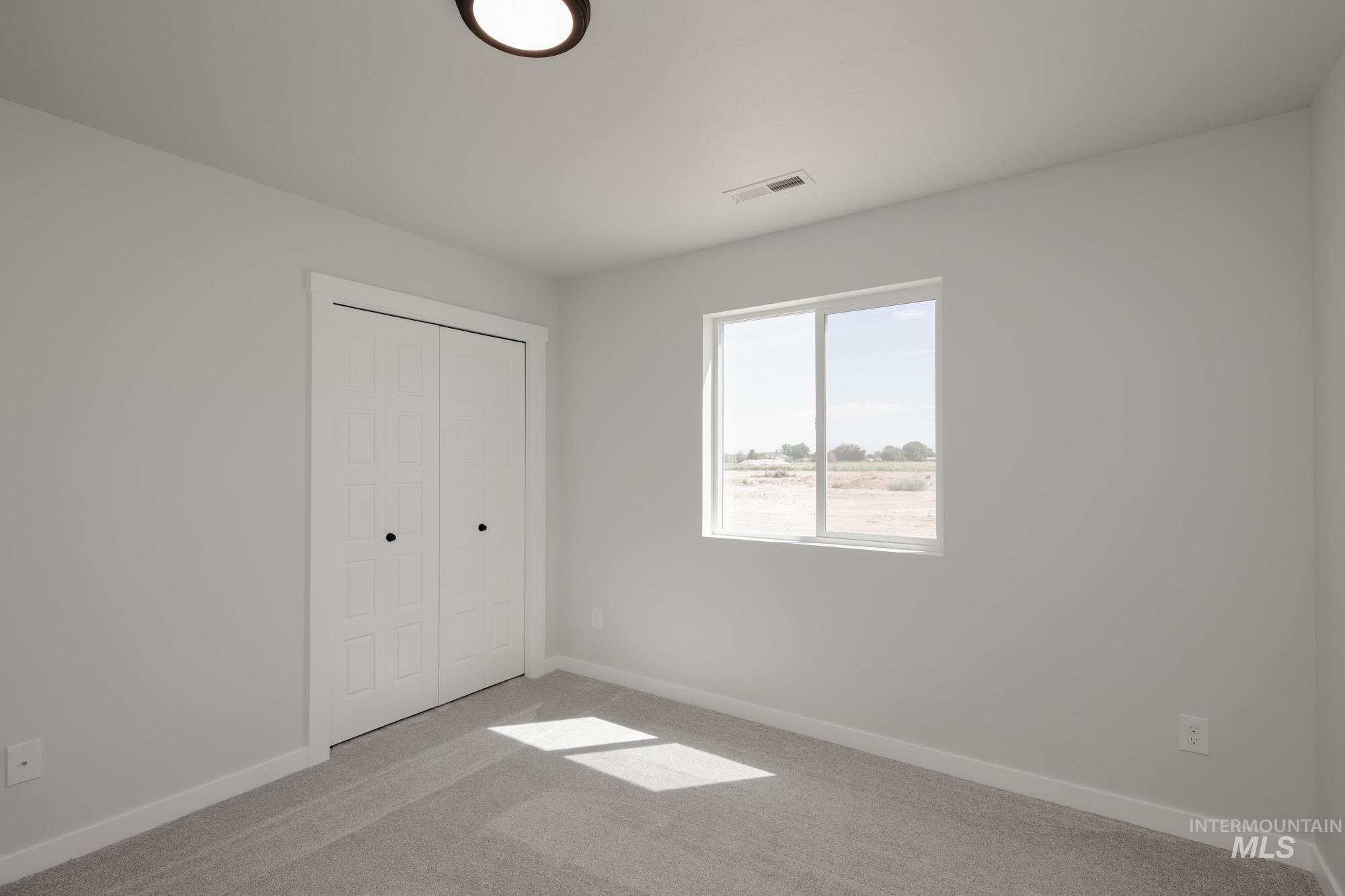 Unfurnished bedroom featuring a closet and carpet floors