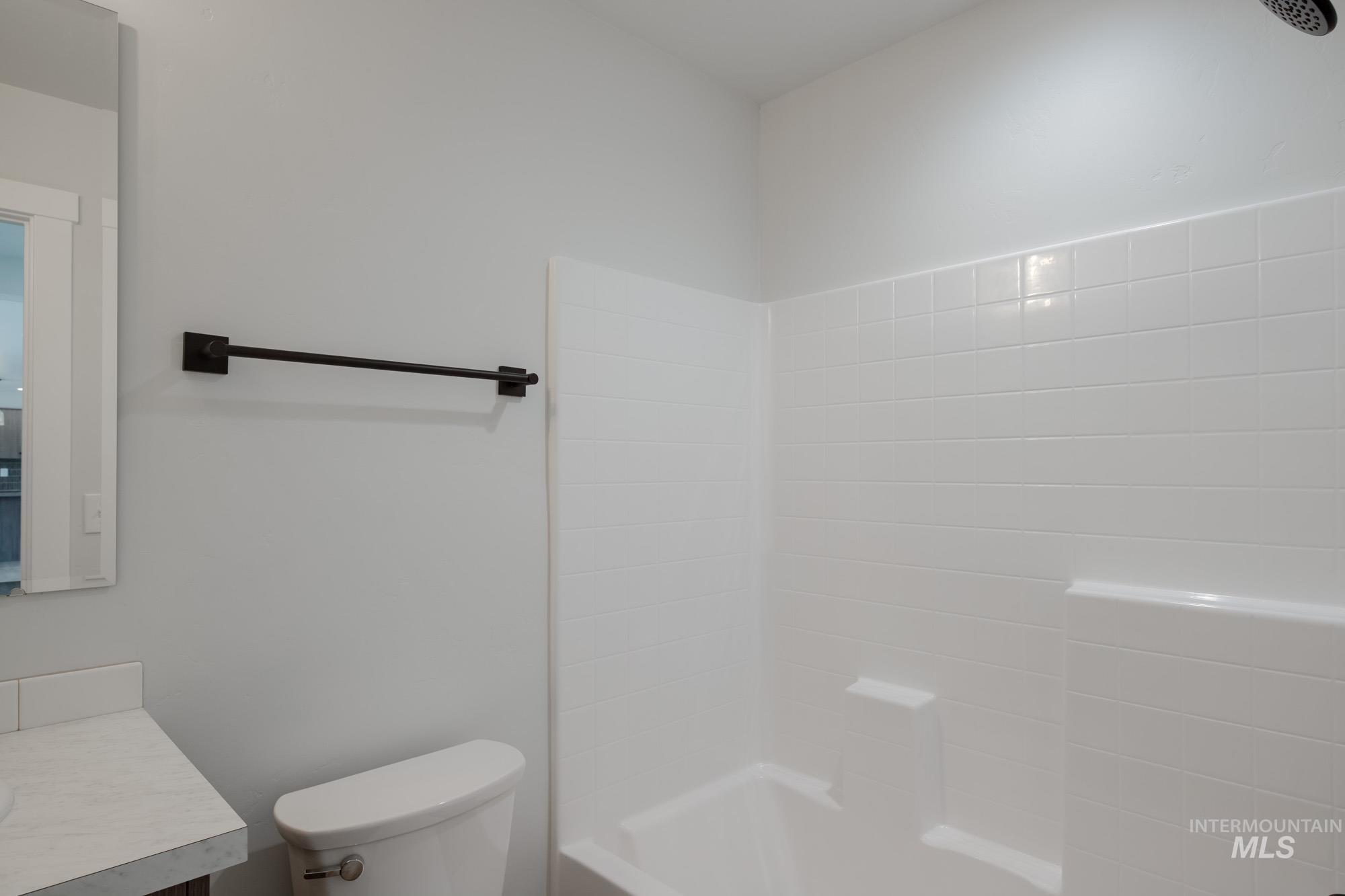 Bathroom featuring vanity and shower / washtub combination