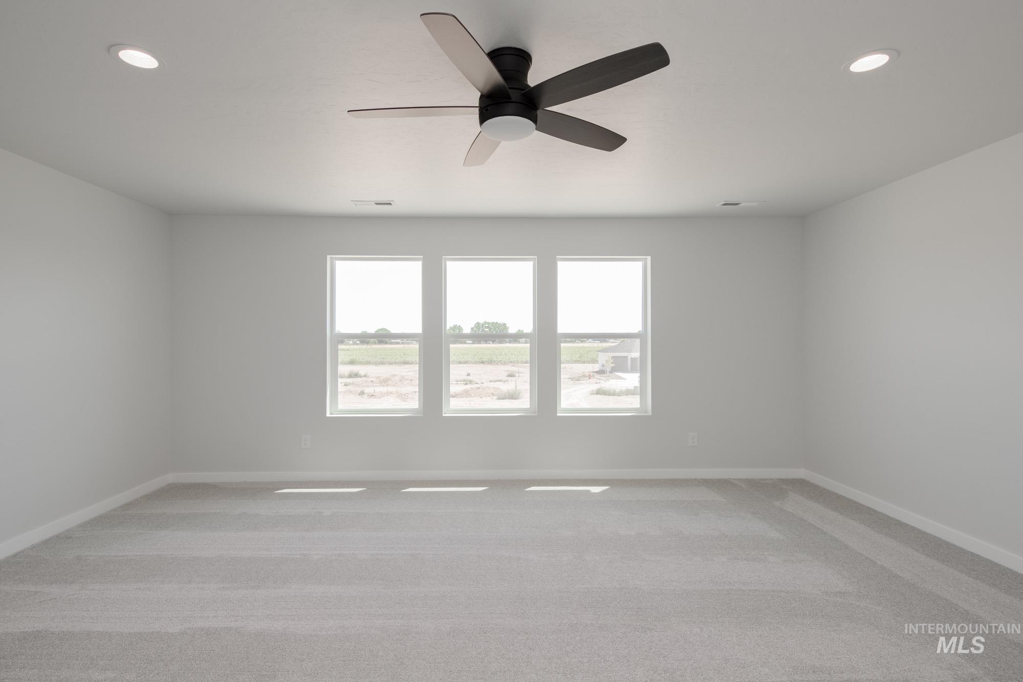 Spare room with light colored carpet, recessed lighting, and ceiling fan