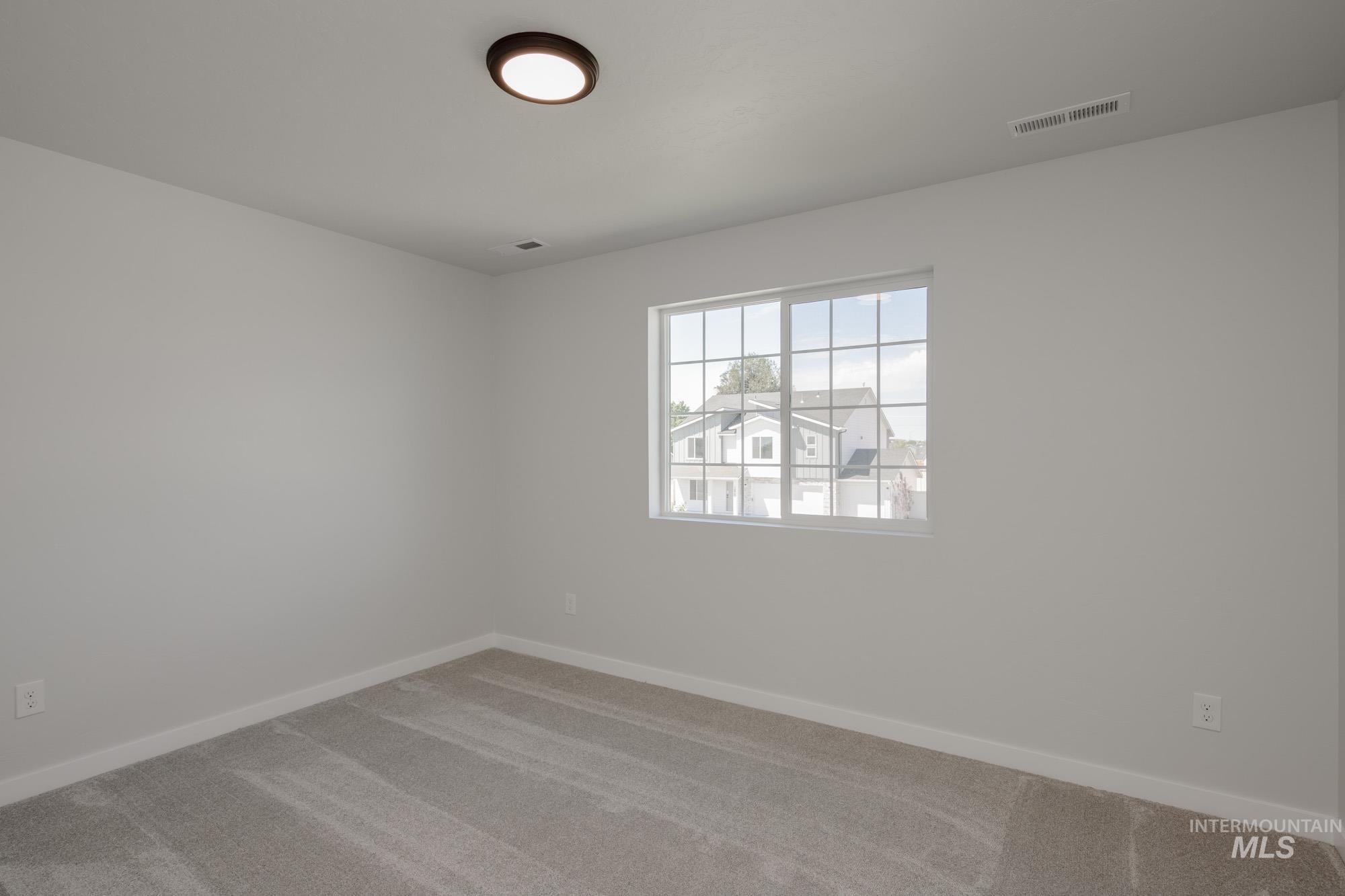 Empty room featuring carpet floors and baseboards