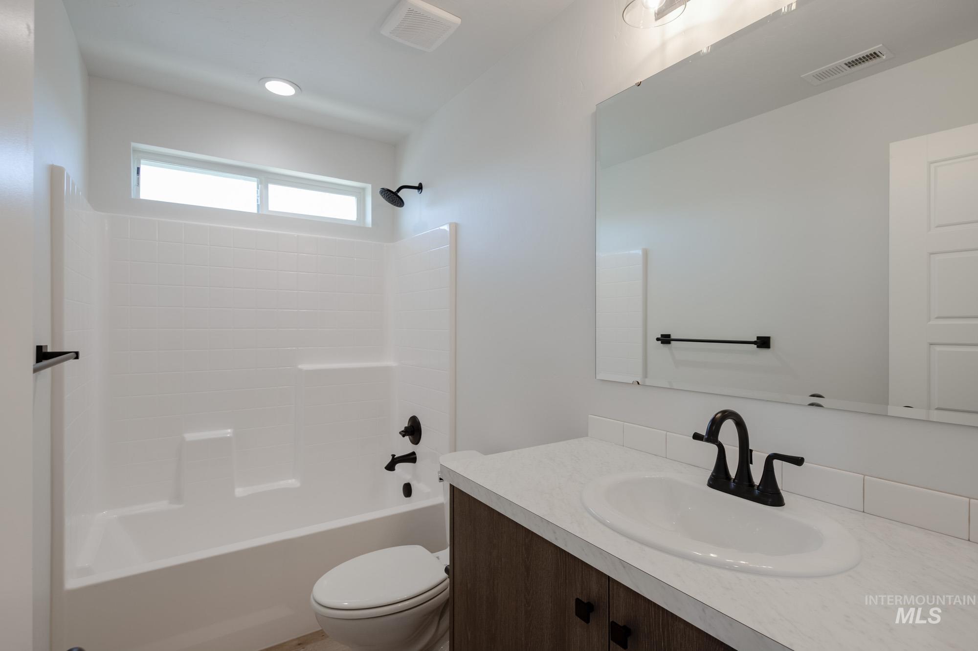Full bathroom featuring shower / washtub combination and vanity