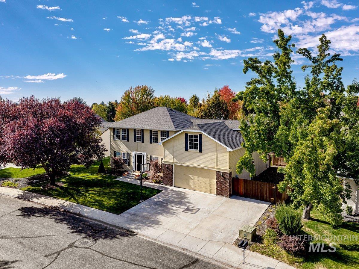 View of front of property featuring concrete driveway and a garage