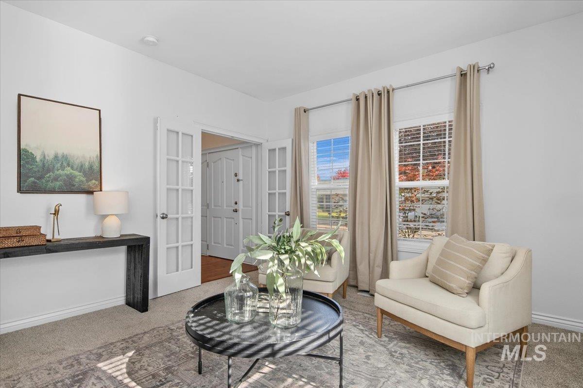 Sitting room with carpet flooring and french doors