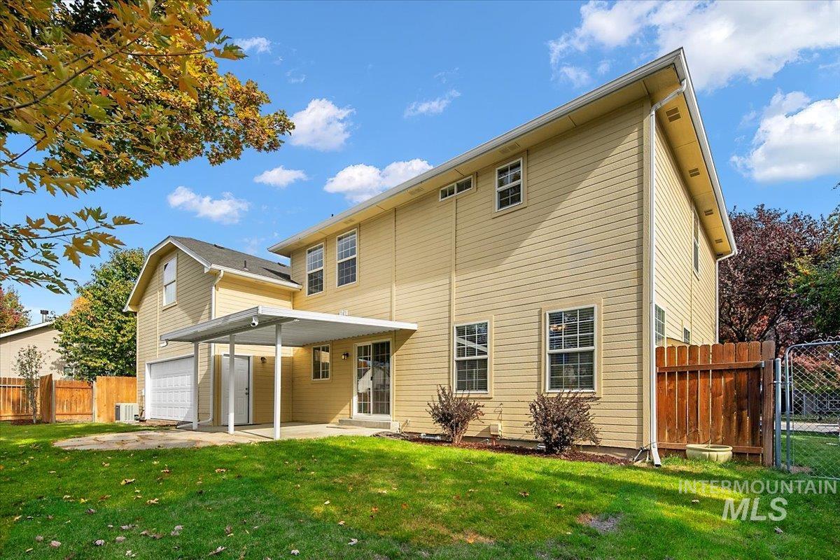 Back of house with a patio and a gate